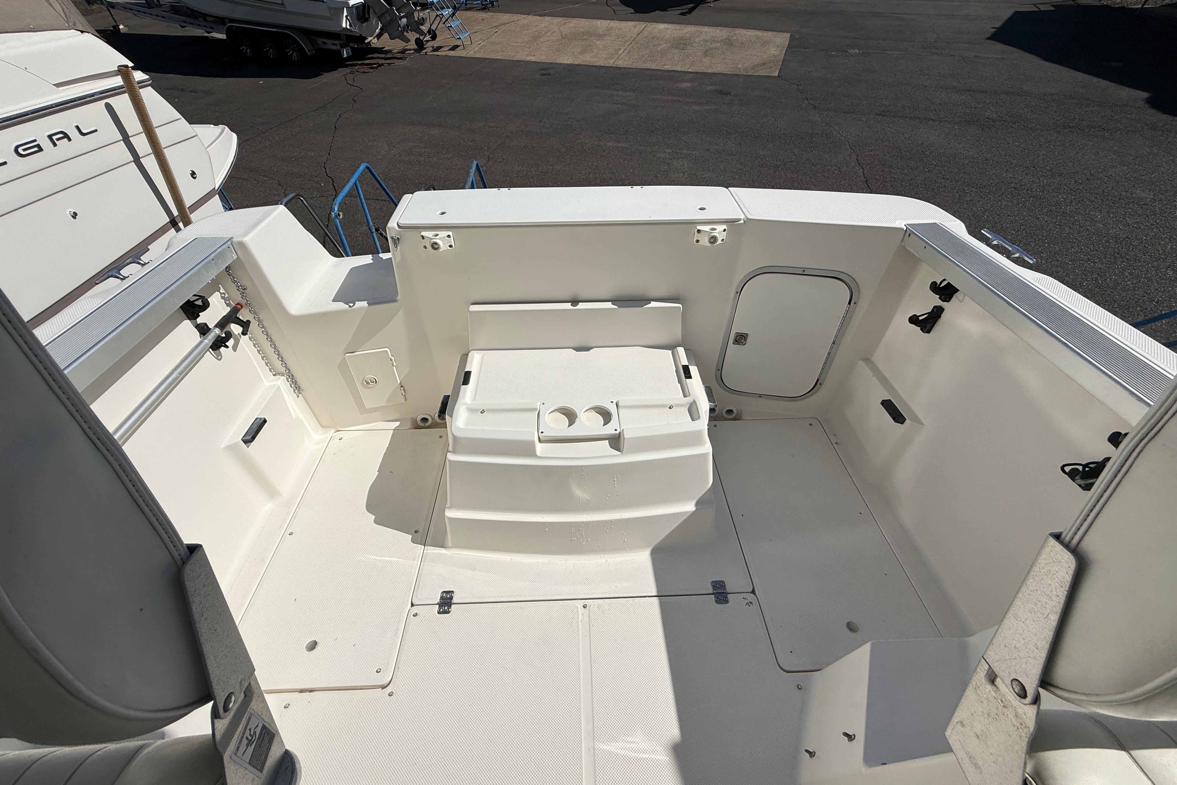 1997 Bayliner 2452 Ciera Express boat deck, featuring spacious seating and storage compartments.