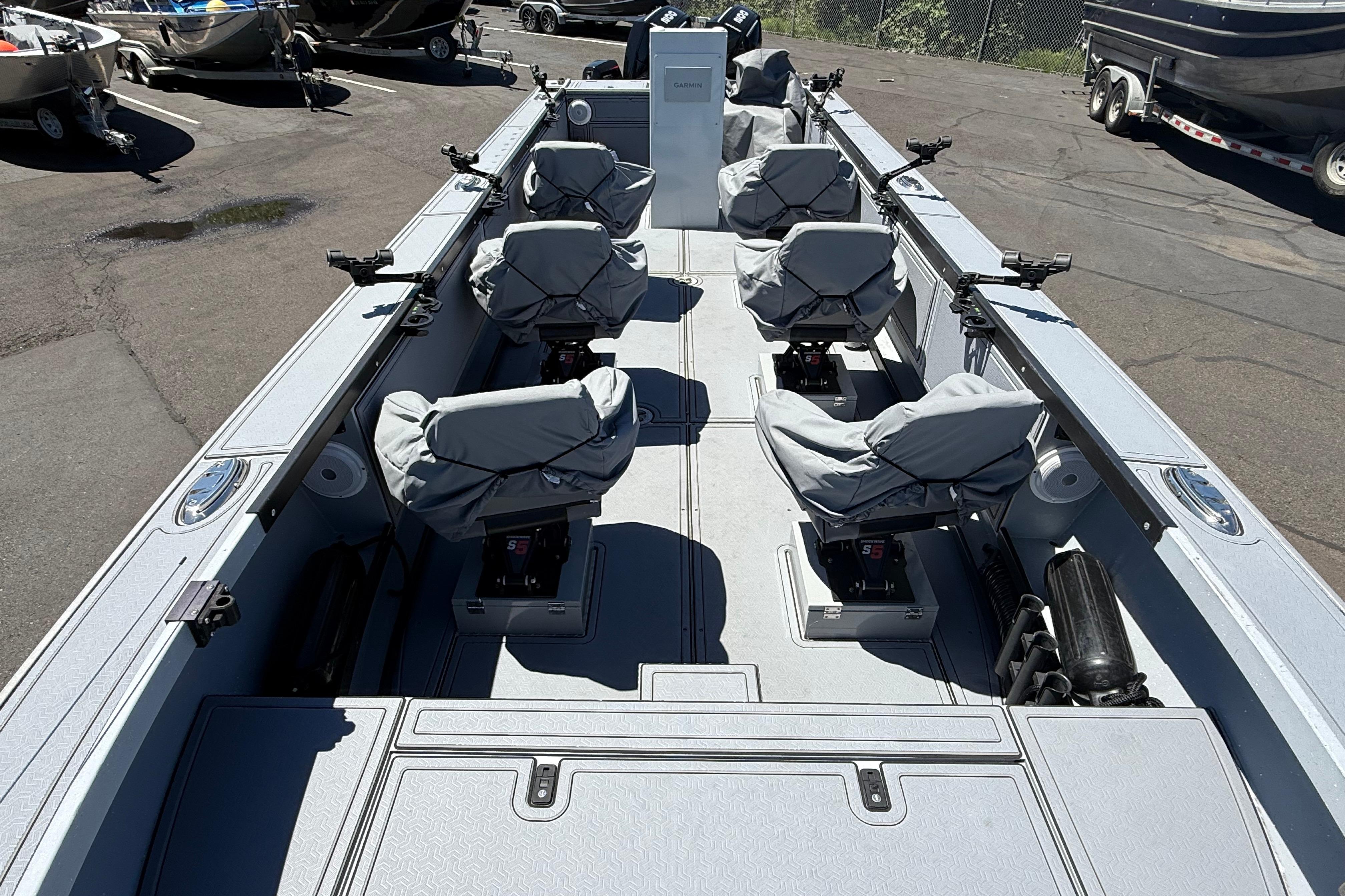 2015 Alumaweld Pacific XD 28 boat interior with covered seats and fishing rod holders.