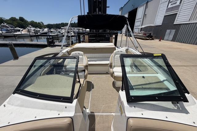 2018 Sea Ray SPX 190 boat docked at marina, featuring open seating and windshield.
