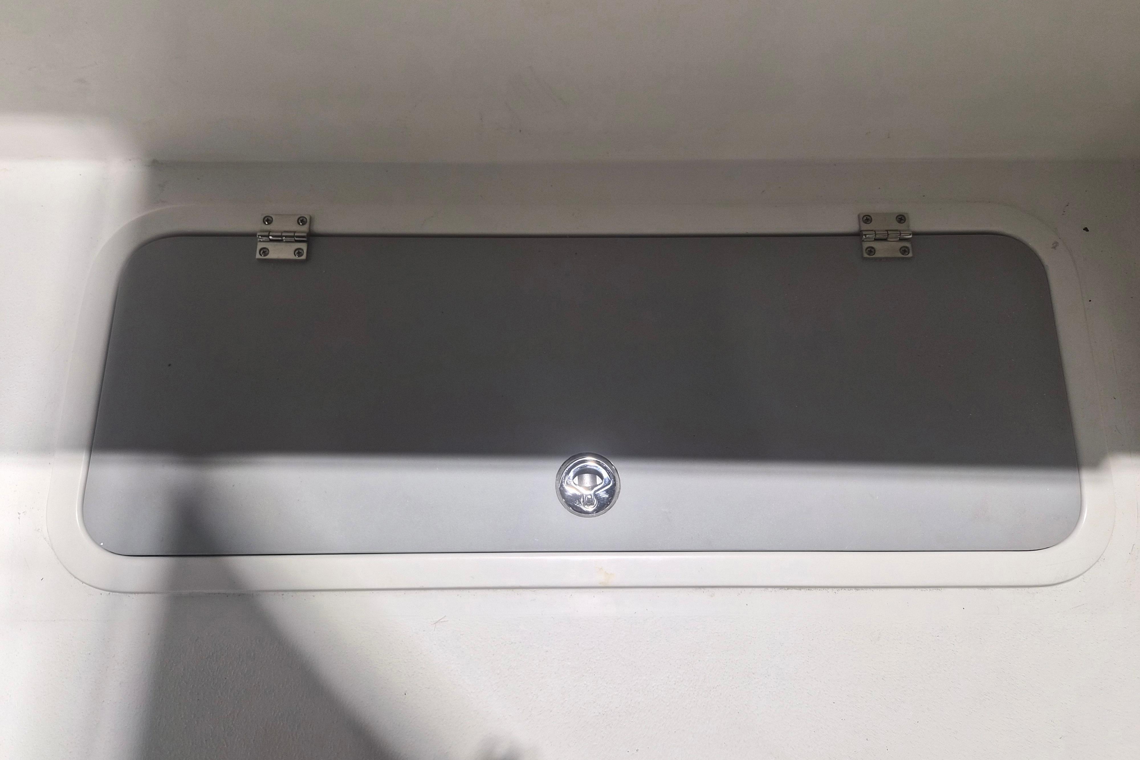 Hatch cover on 2026 Defiance Admiral 260 EX boat, featuring secure hinges and latch.