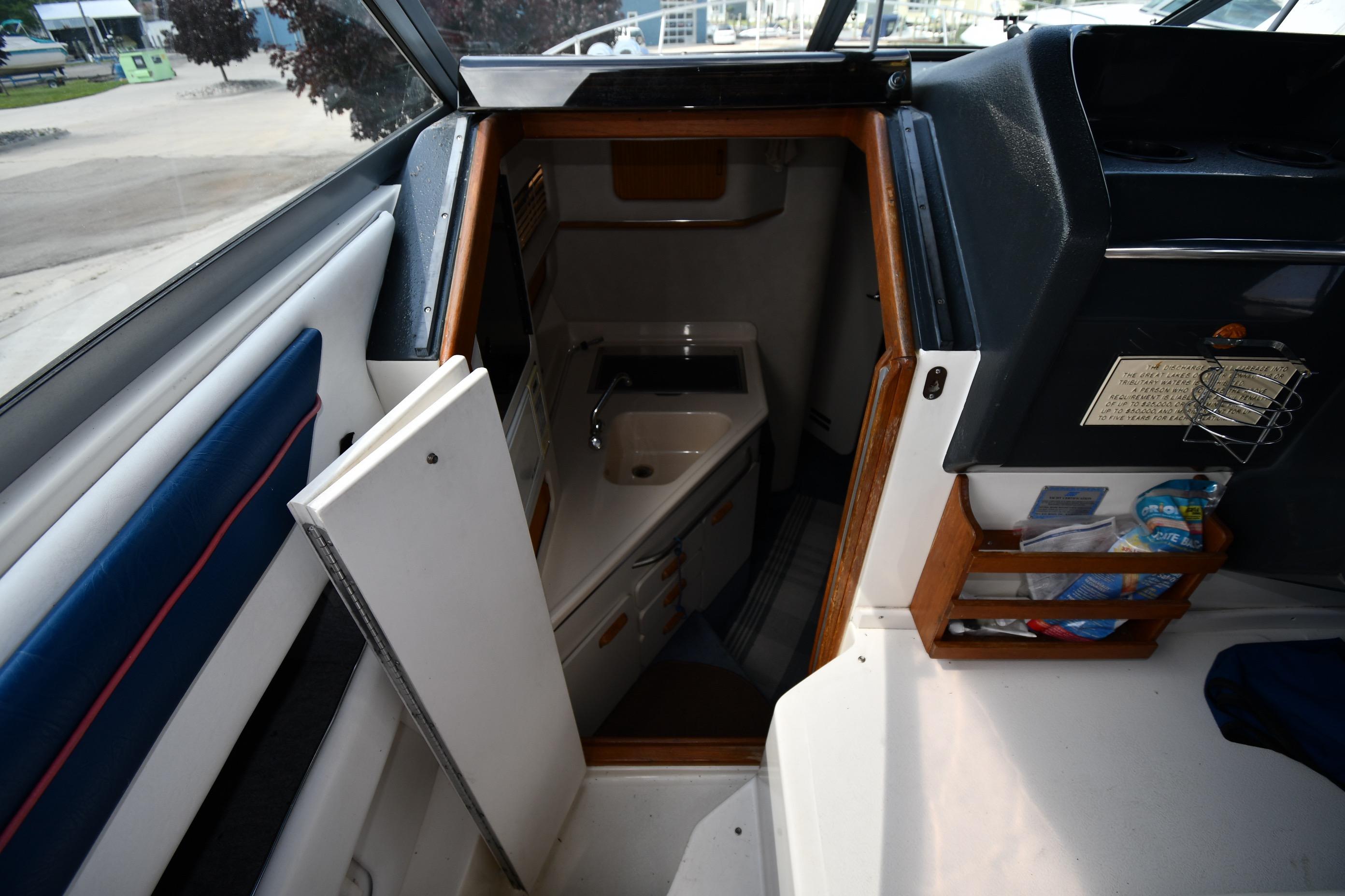 Interior view of a 1993 Sea Ray 300 Sundancer cabin with sink and storage.