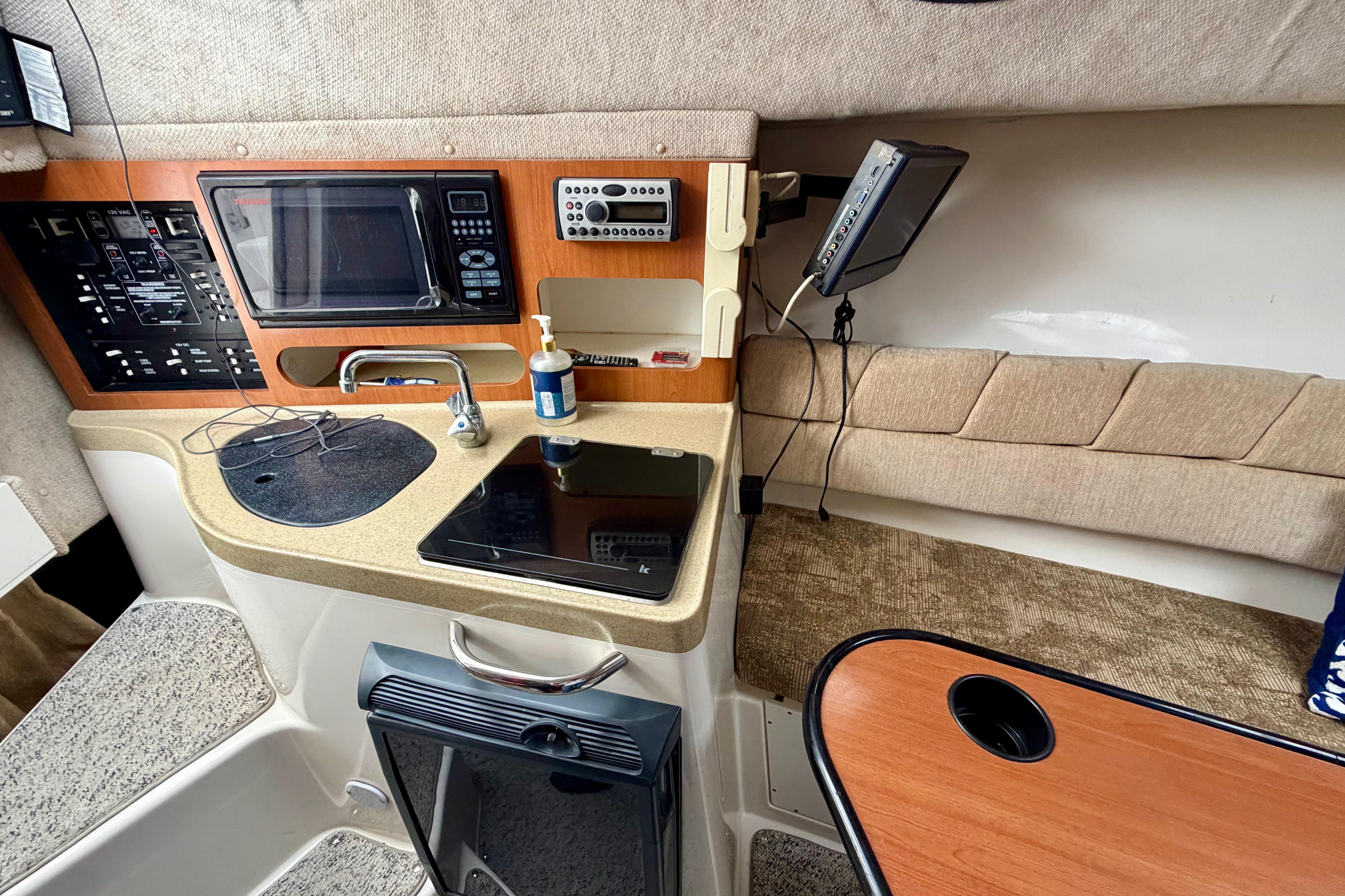 2006 Seaswirl Striper 2901 Walkaround O/B cabin interior with kitchenette and seating area.