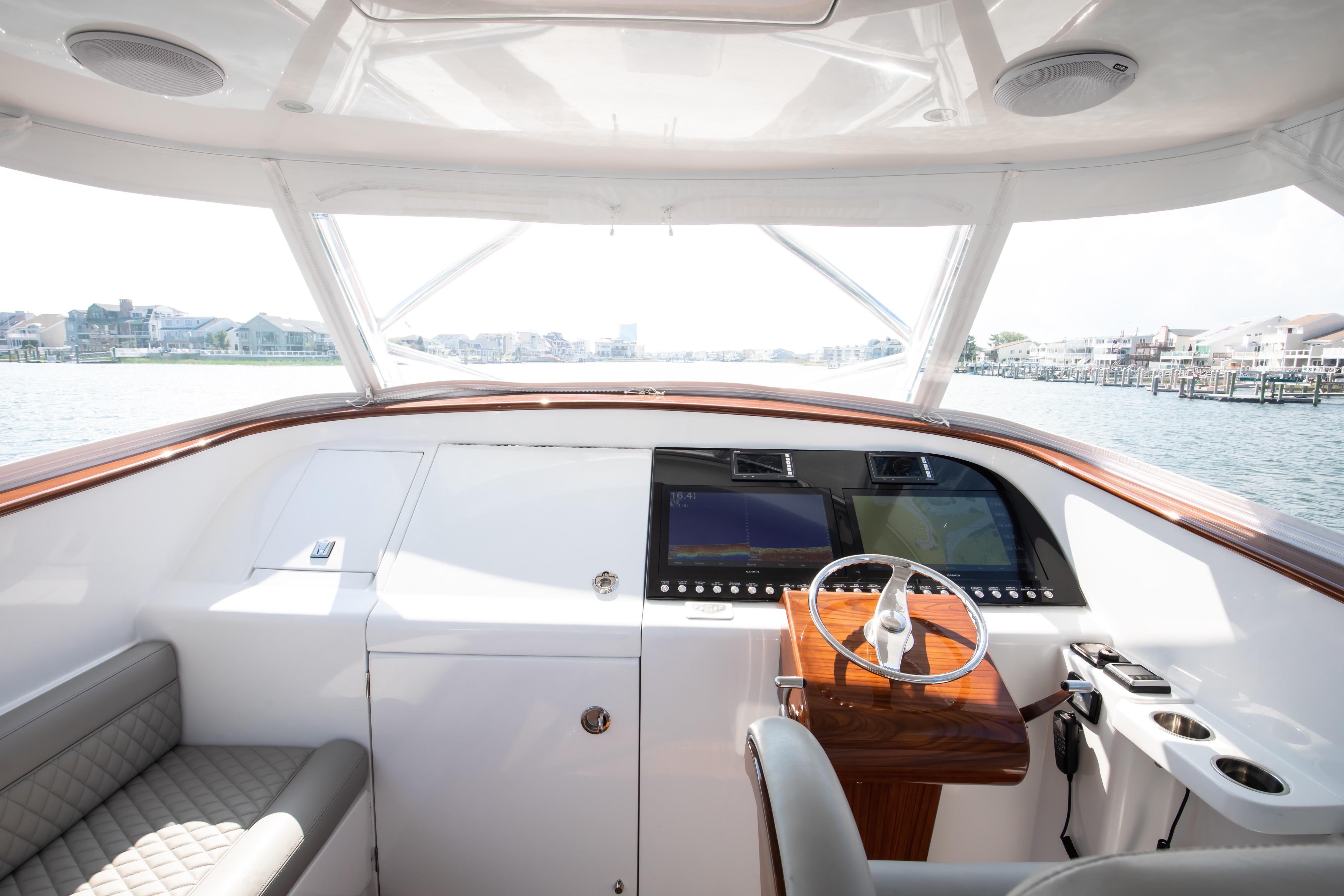 Helm of 2026 Release Boatworks 46 Walkaround with modern controls and waterfront view.