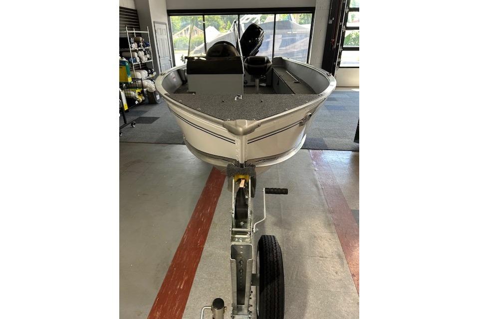 2027 Lund 1600 Fury SS boat on trailer in showroom.