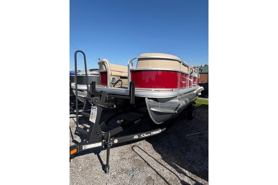 2025 Sun Tracker Party Barge 18 DLX pontoon boat on trailer, red and beige design.