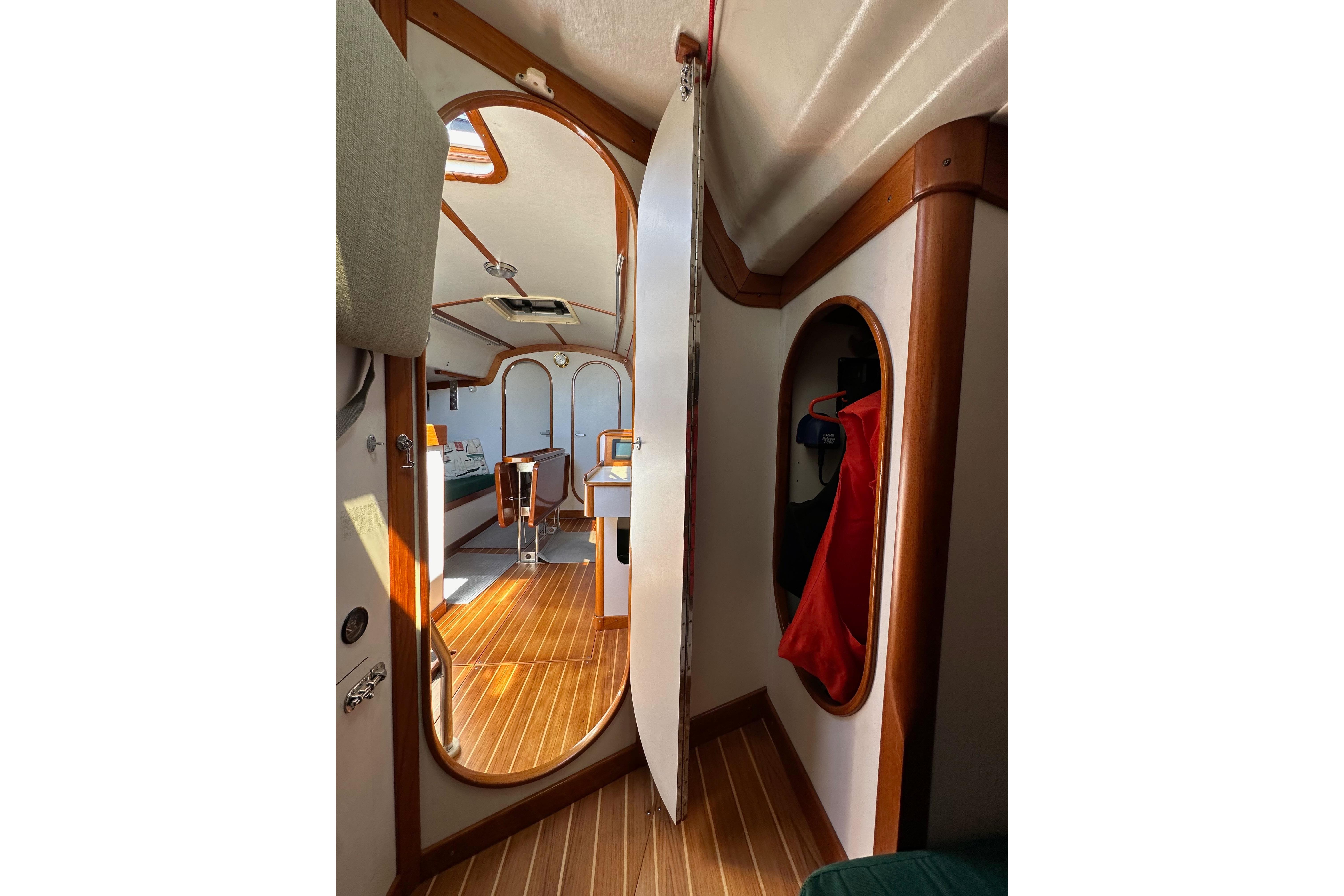 Interior of 1996 J Boats J/120 sailboat, featuring wood accents and cozy cabin space.