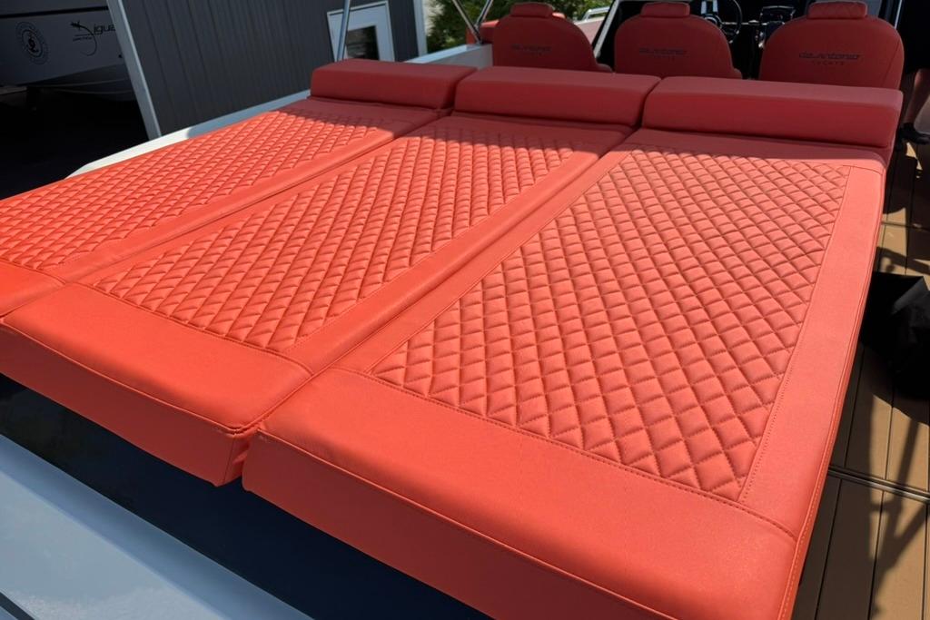 Red quilted seating on 2020 De Antonio Yachts D28, showcasing luxury and comfort.