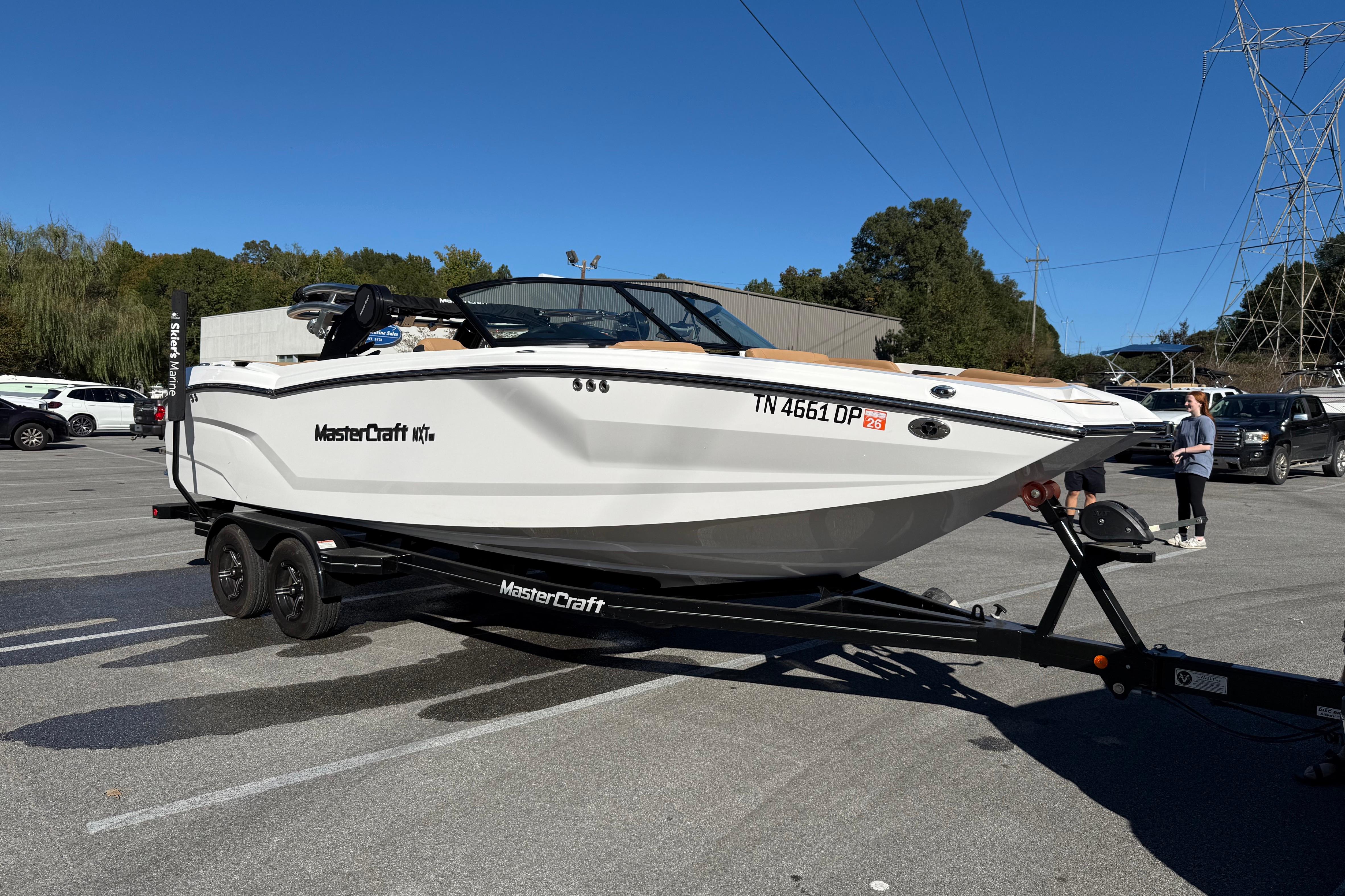 2022 MasterCraft NXT24 boat on trailer in parking lot.