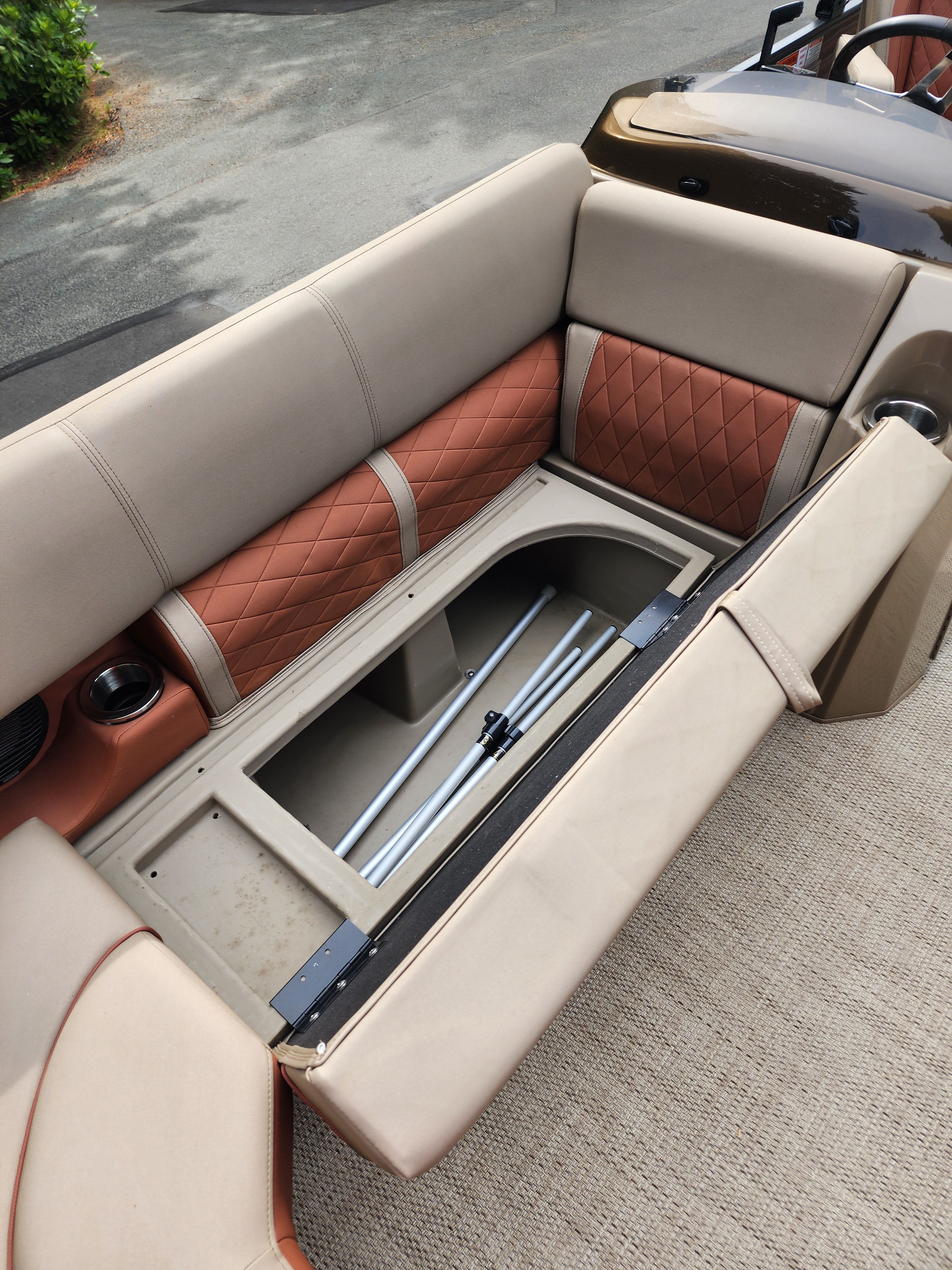 The image shows the seating area of a Bennington 22 LSB with storage underneath.
