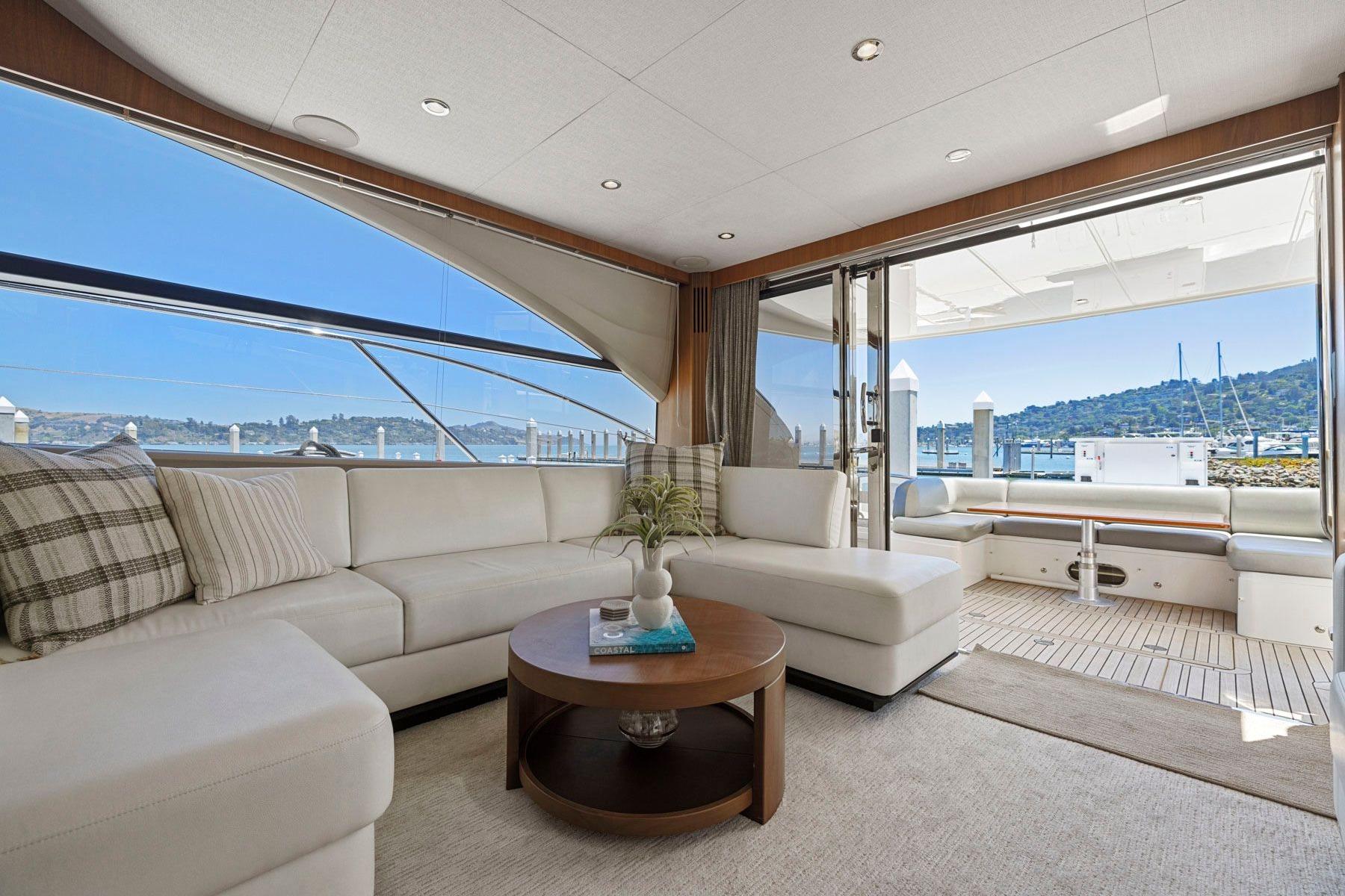 Luxurious interior of a 2015 Princess 60 Flybridge Motor Yacht with scenic marina view.