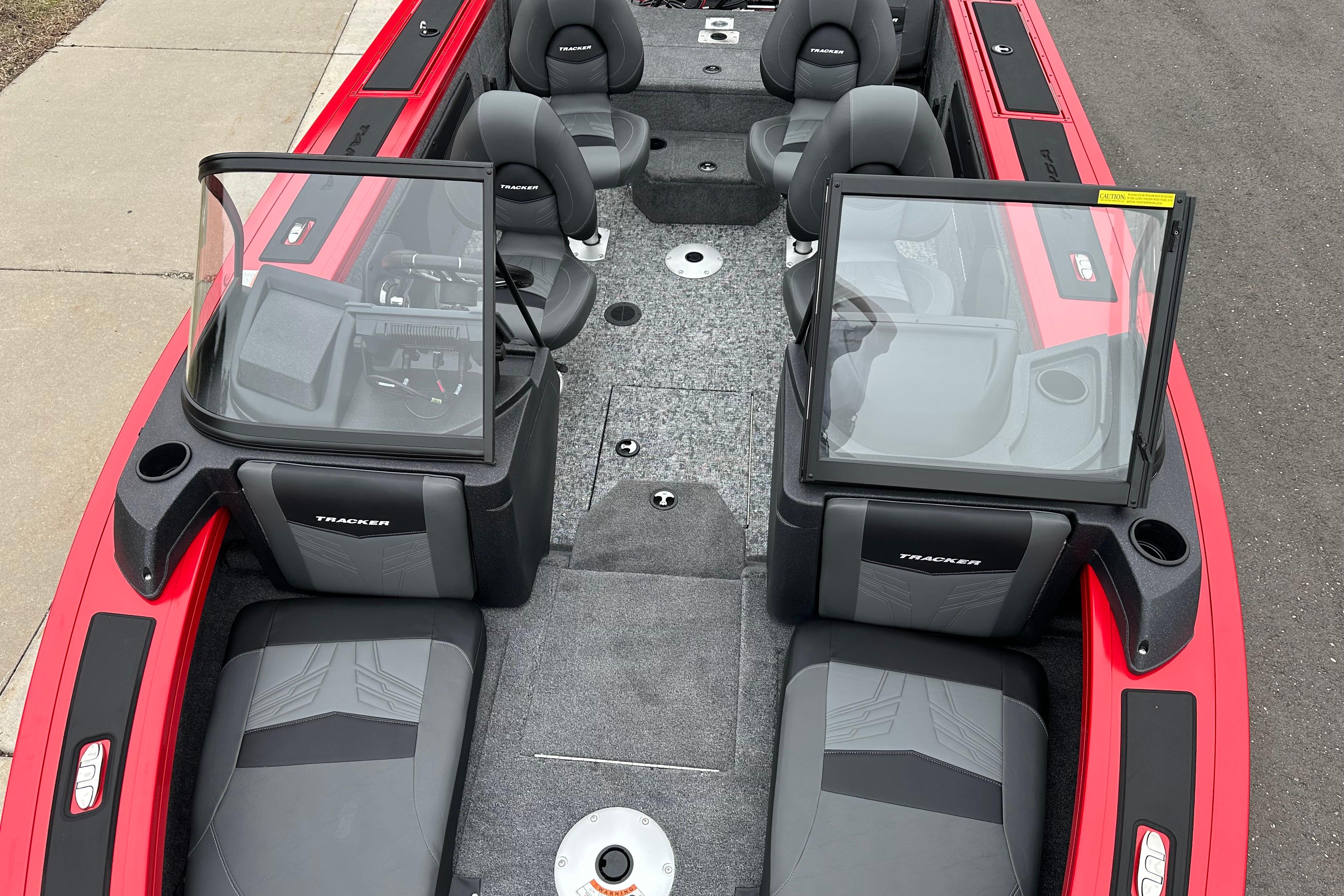 2026 Tracker Targa V-19 Combo boat interior with seating and windshield, parked on pavement.