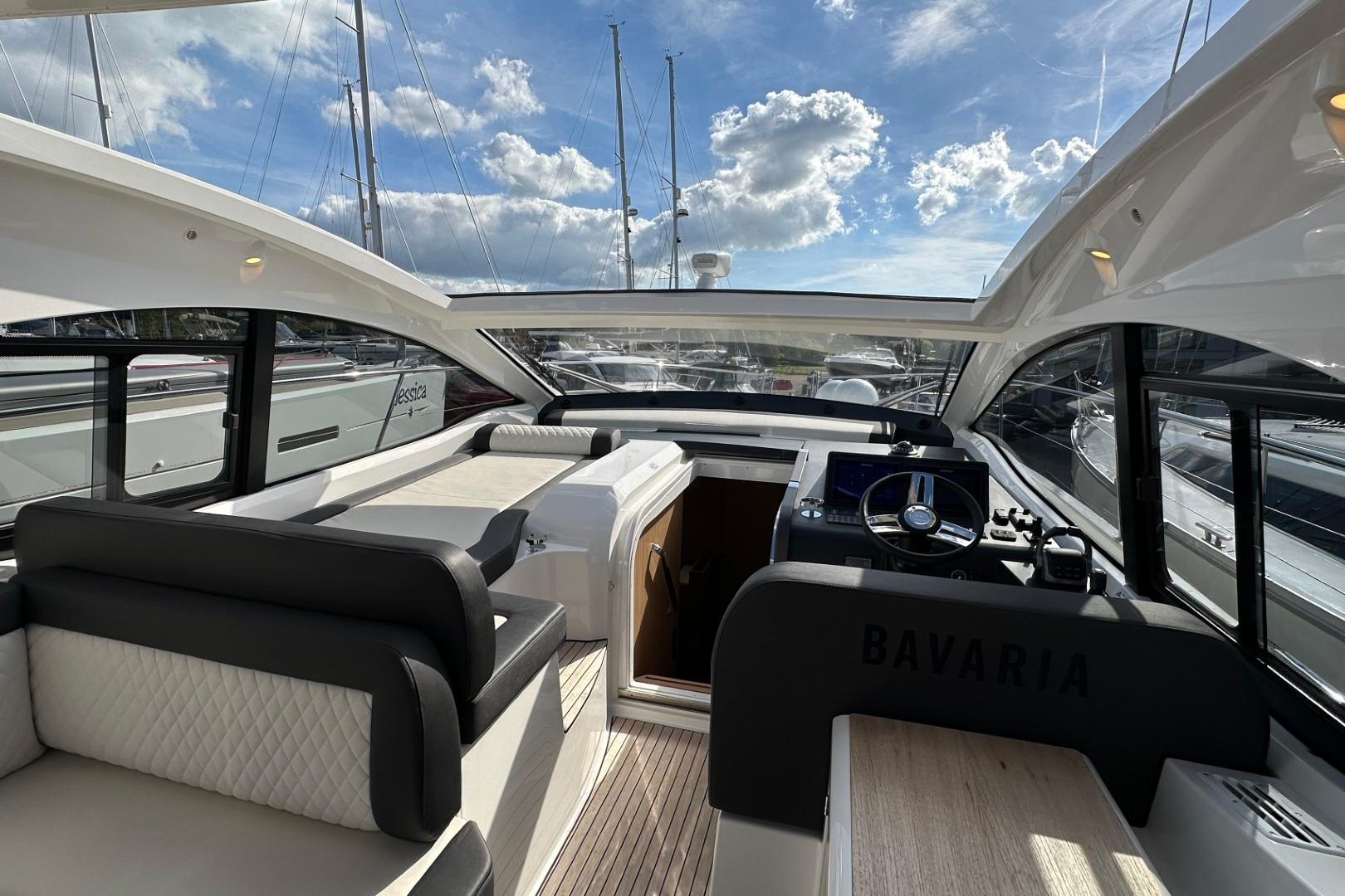 2023 Bavaria SR41 yacht interior with modern helm, seating, and panoramic windows.
