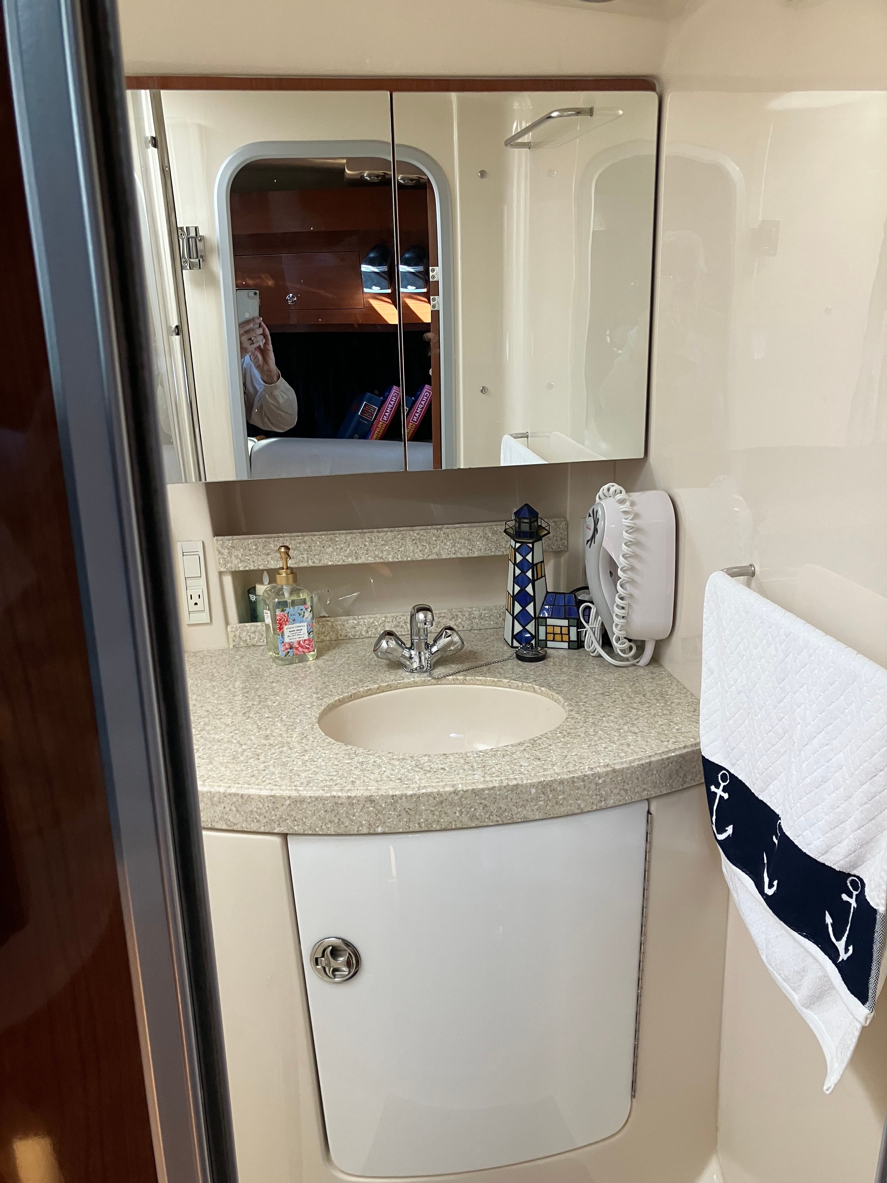 Bathroom in a 2008 Custom Commodore yacht with mirror and sink.