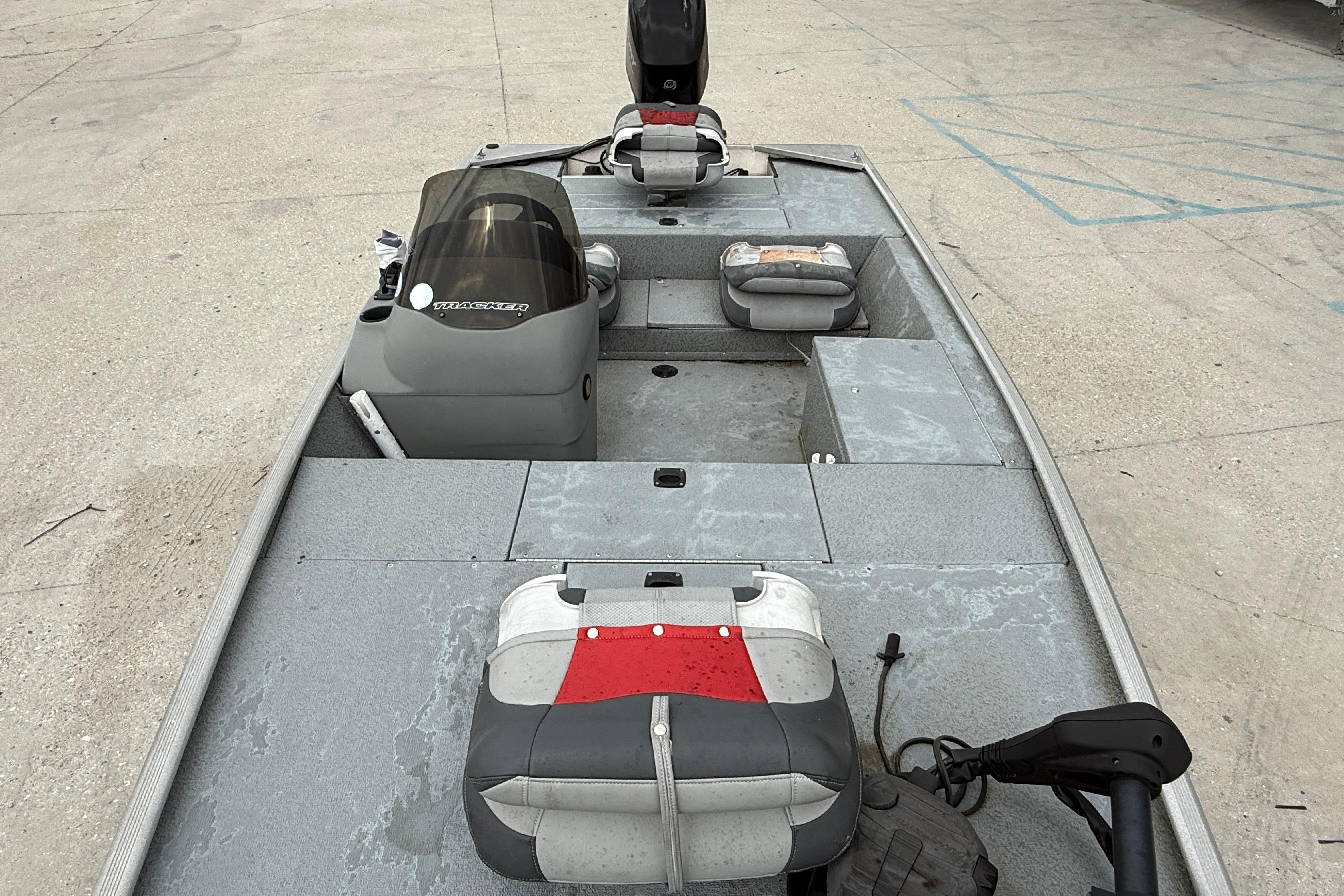 2016 Tracker Pro 170 boat interior with seating and controls on concrete surface.