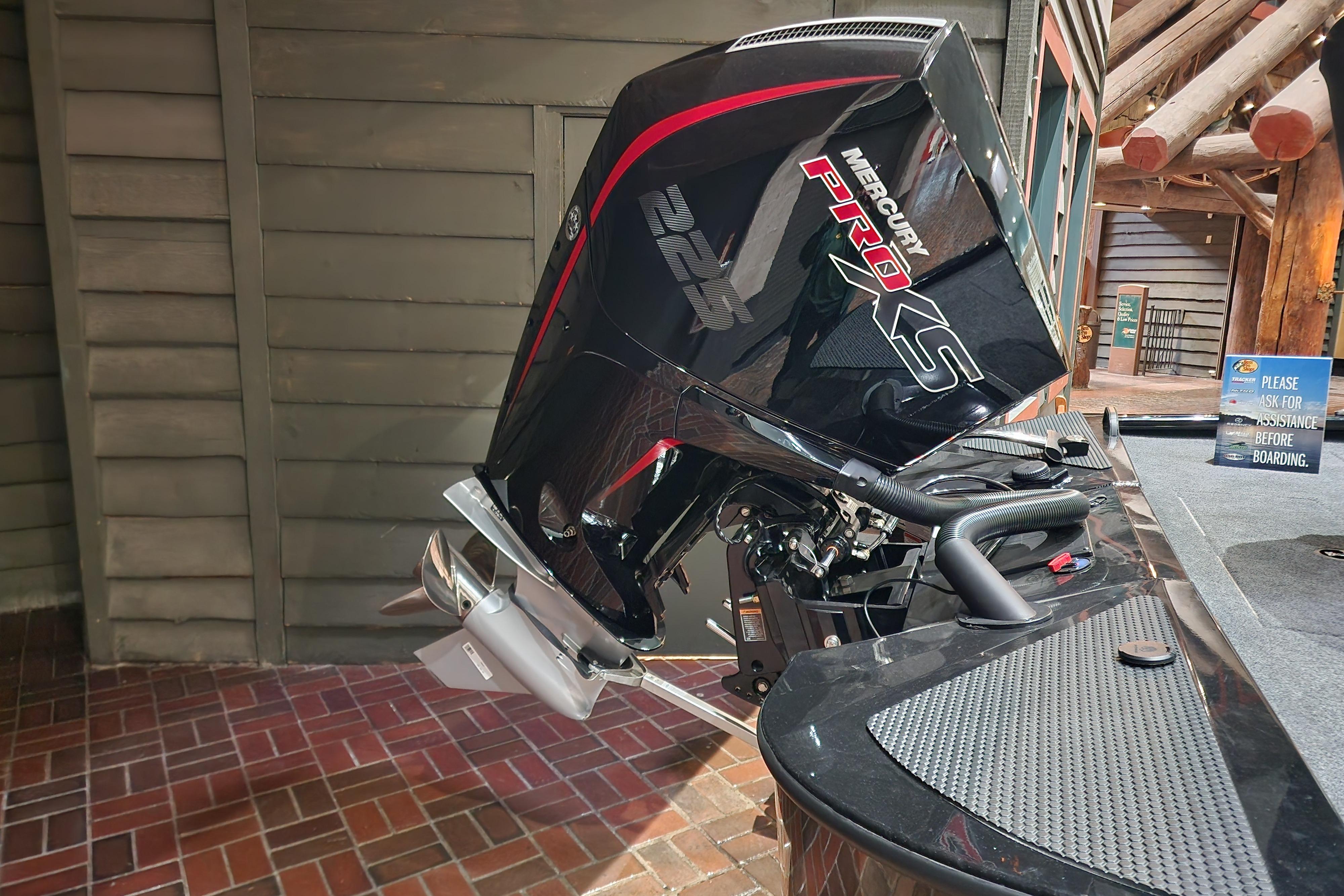 2025 Tracker Savage 215 boat with Mercury Pro XS outboard motor, displayed indoors.