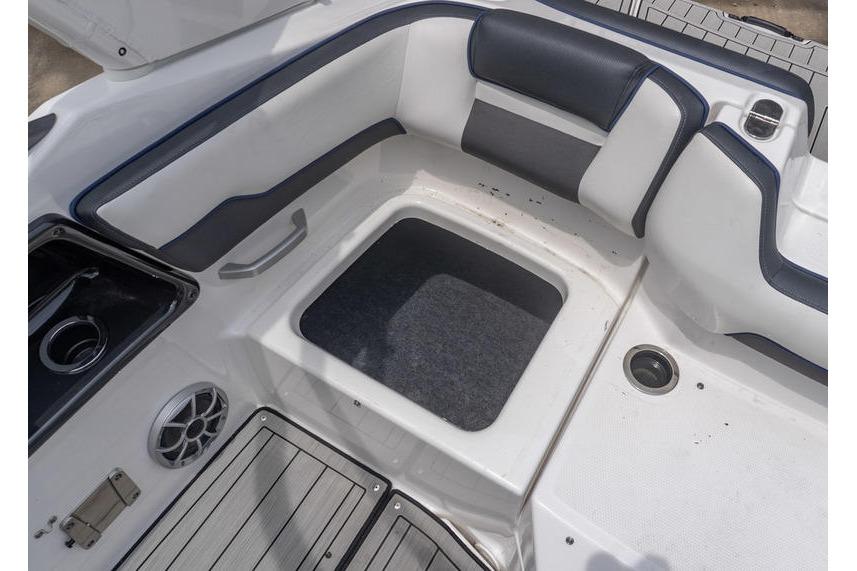 2021 Yamaha Boats 195S interior seating with storage compartment and speaker.