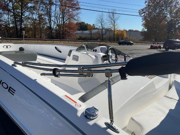 2025 Tahoe T18 boat interior with steering wheel and seating, parked outdoors.