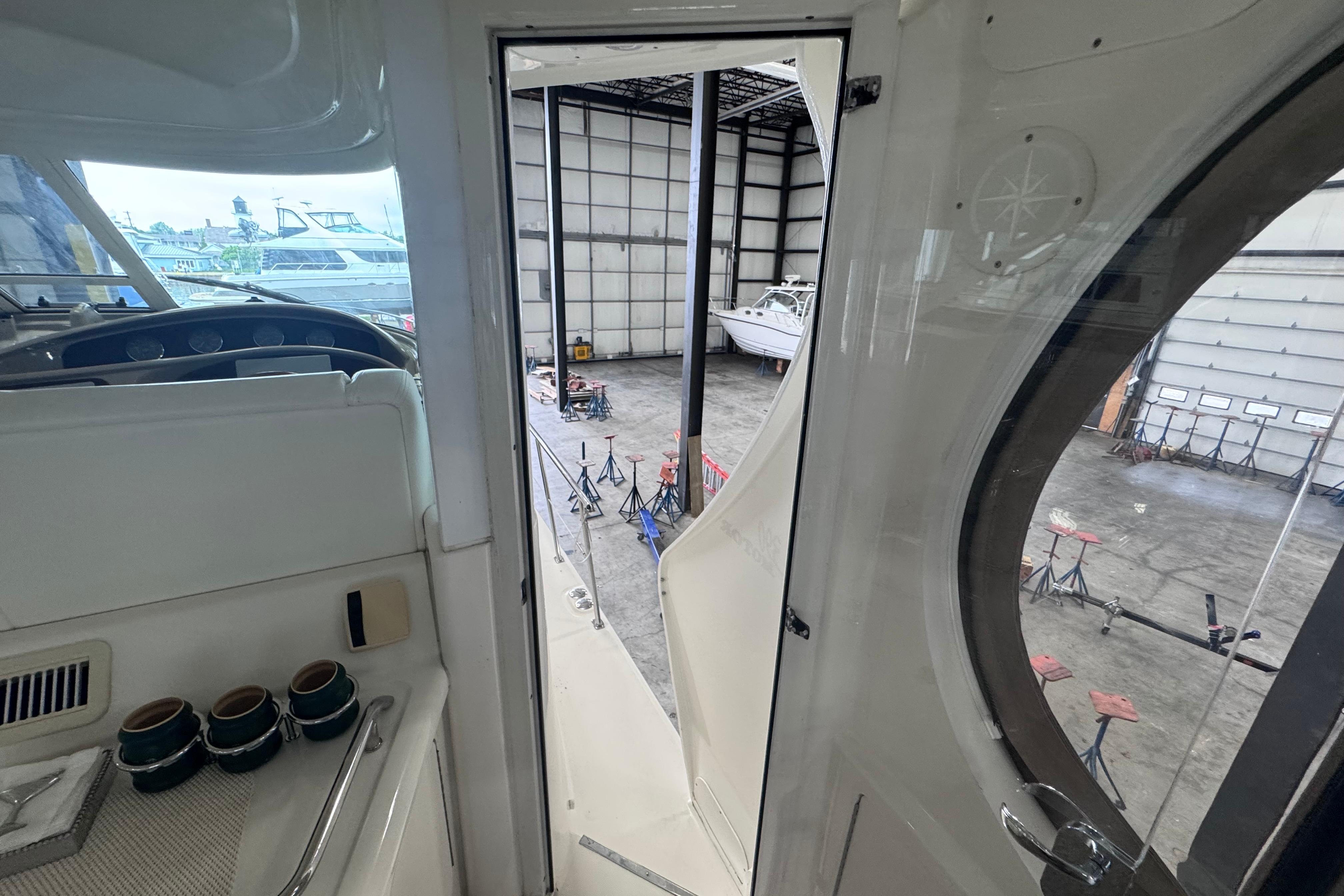 2004 Sea Ray 390 Motor Yacht interior view, showing cockpit and open door to marina.