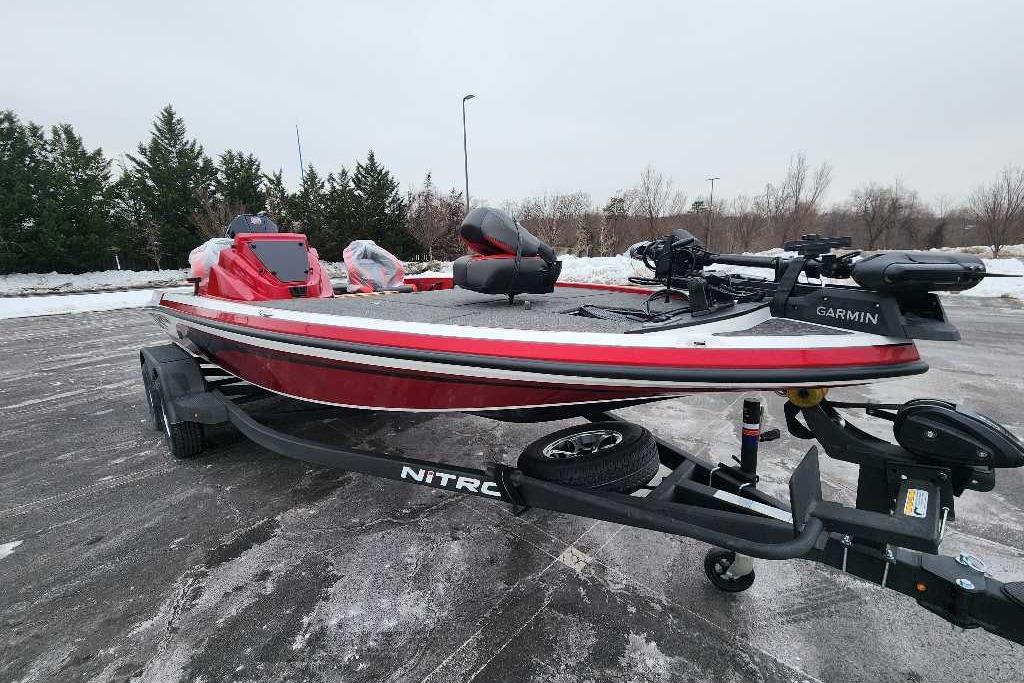 2026 Nitro Z19 XL Pro boat on trailer, red and white design, parked outdoors.