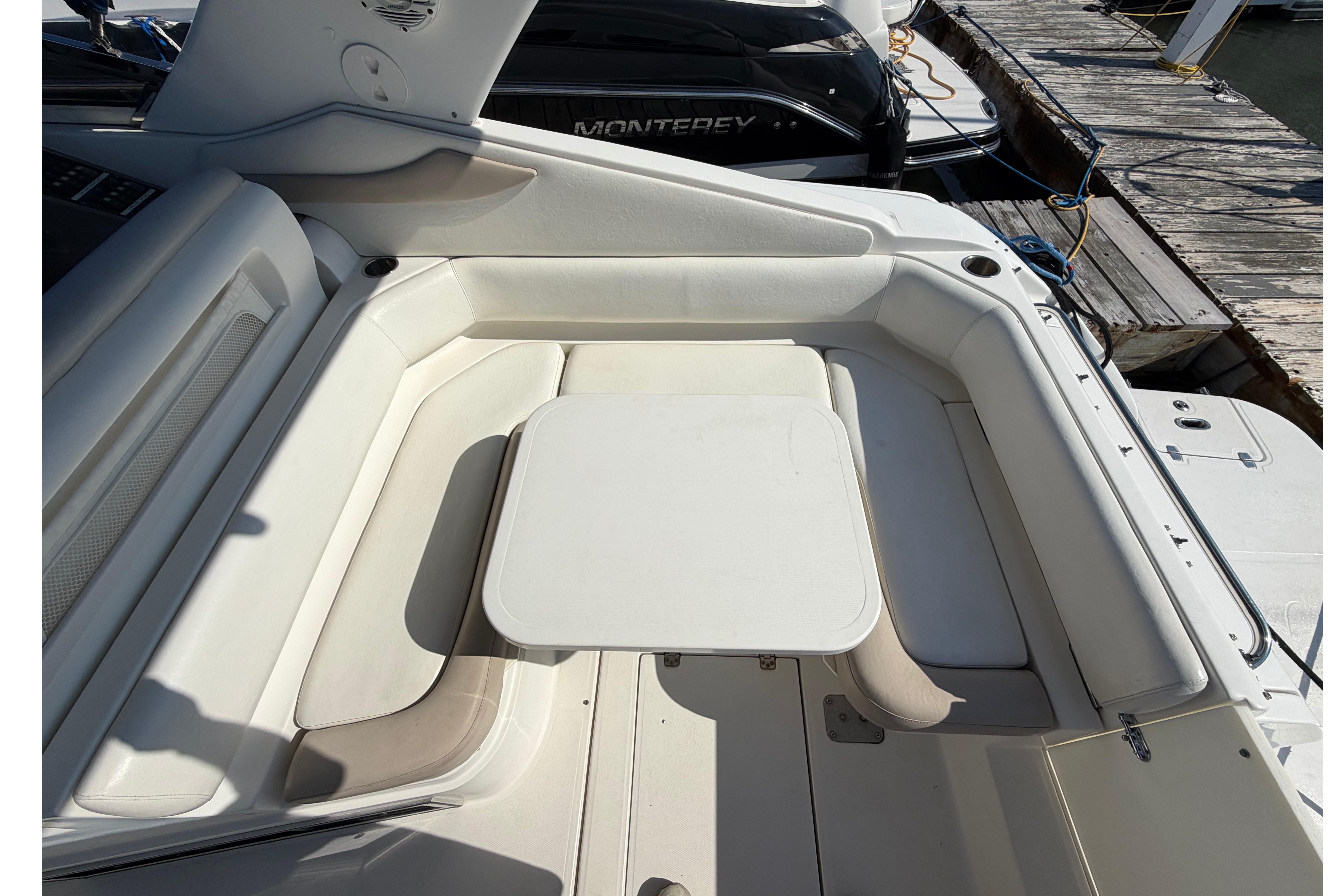 2003 Regal Commodore 3260 boat interior with white seating and table.