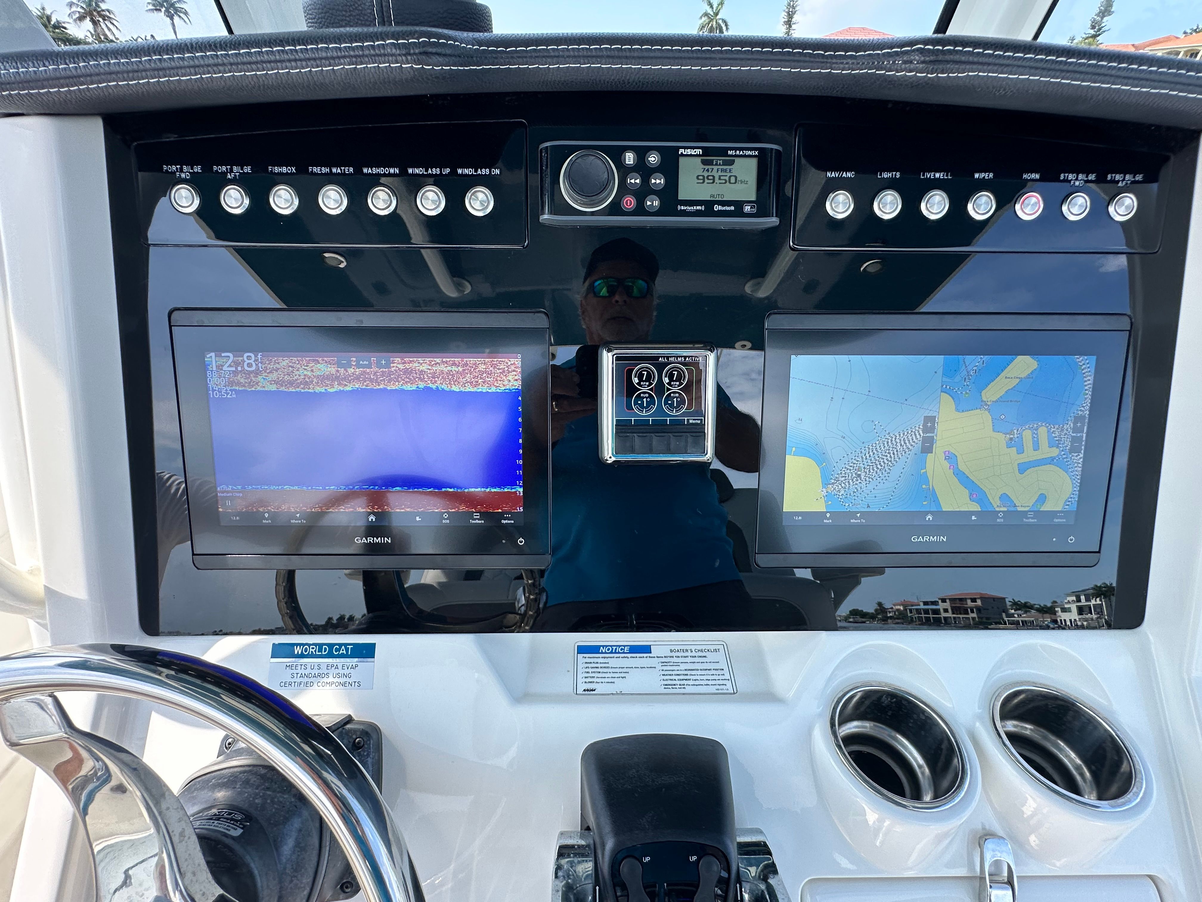 Dashboard of a World Cat 280 CC-X with two Garmin screens and controls.