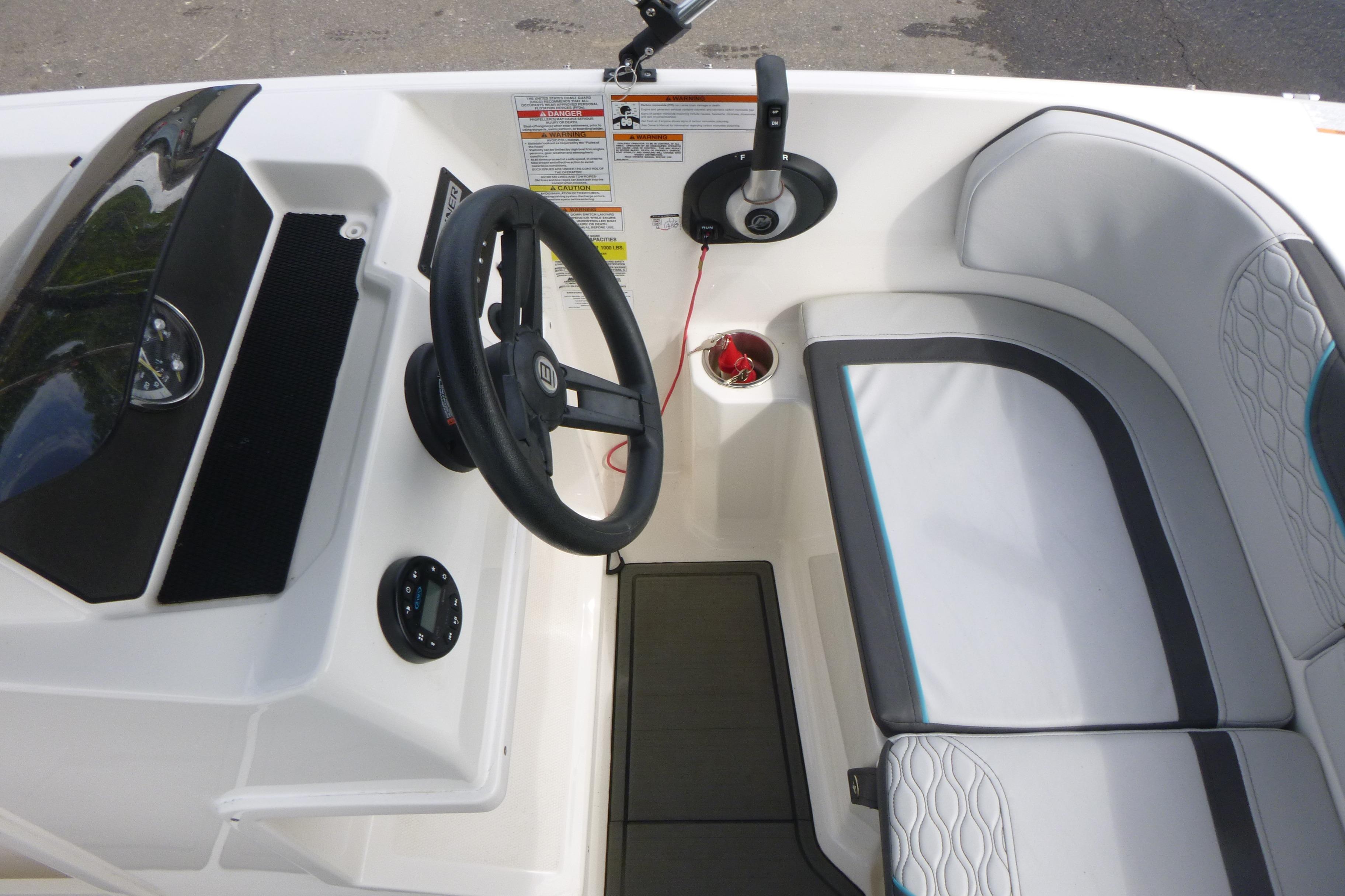 2022 Bayliner Element M17 boat interior with steering wheel and seating area.