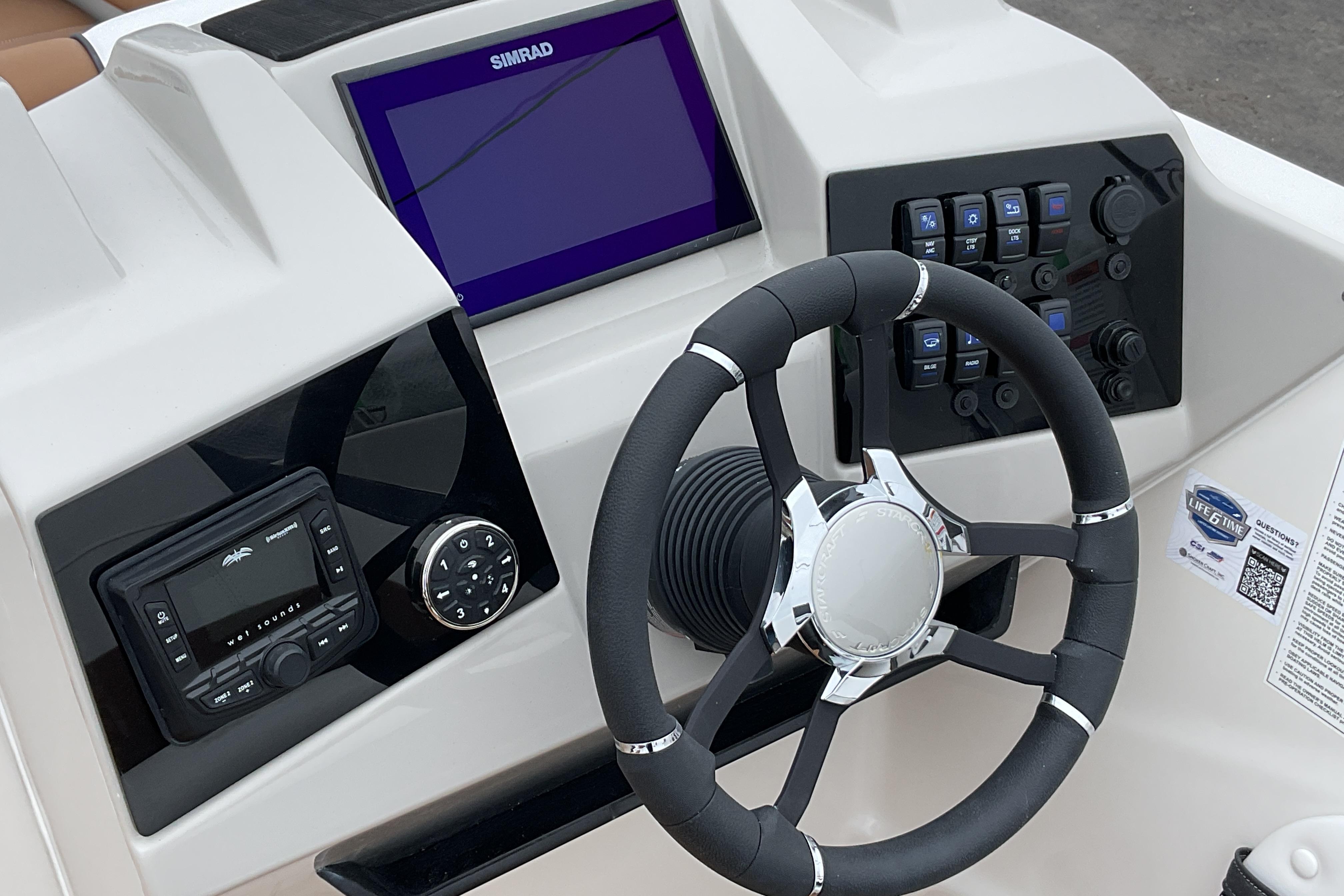 2026 Starcraft SVX 211 OB boat dashboard with steering wheel and control panel.