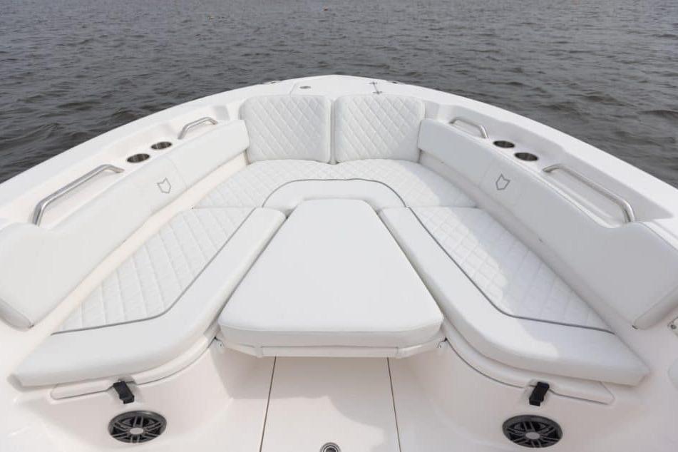 Luxurious seating area on 2027 Sea Fox 248 Commander boat, featuring white cushioned upholstery.