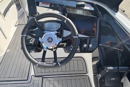 2026 Yamaha Boats 222S steering wheel and dashboard, featuring modern controls and sleek design.