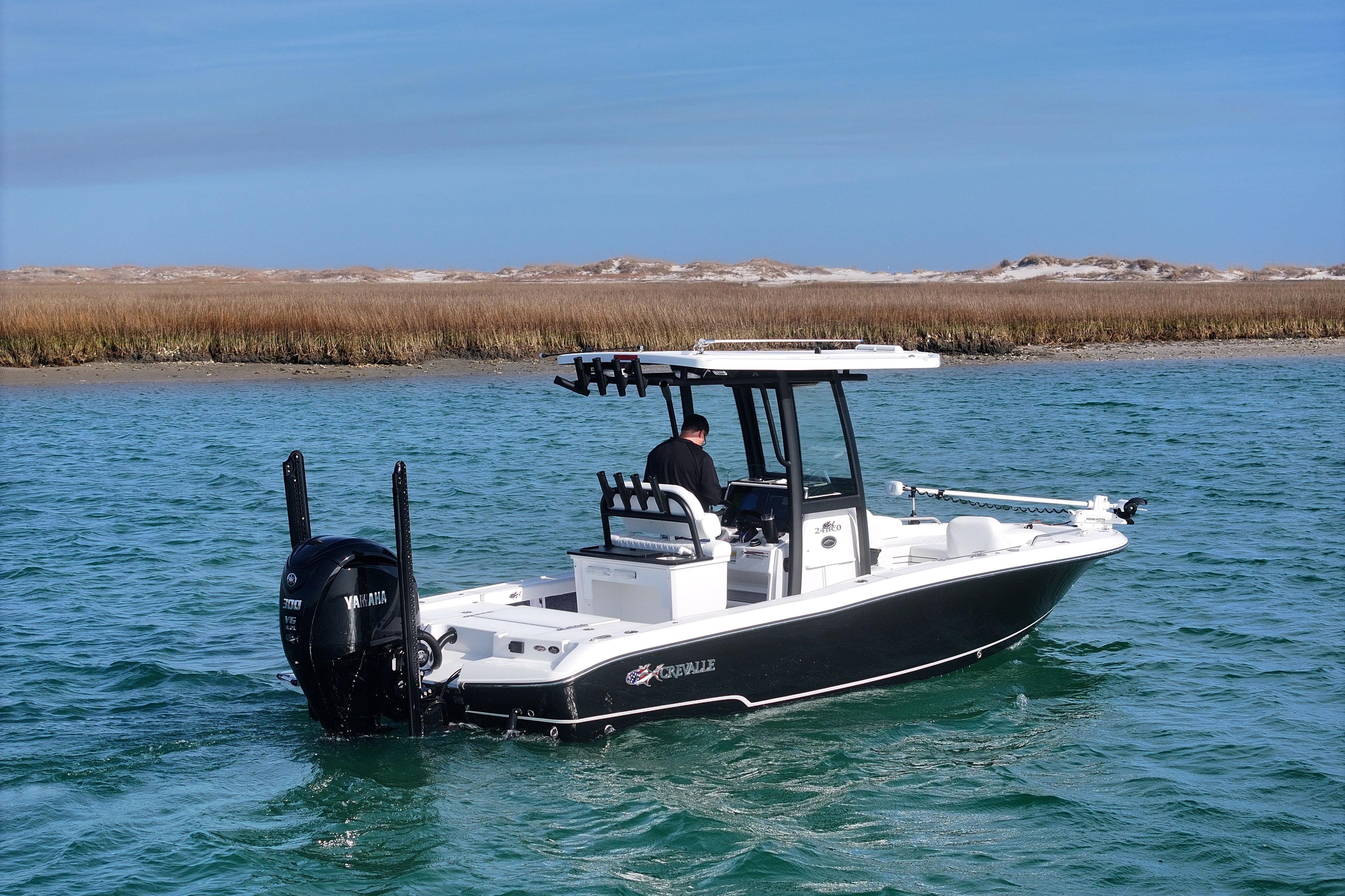 2025 Crevalle 24 HCO boat cruising on a scenic waterway.