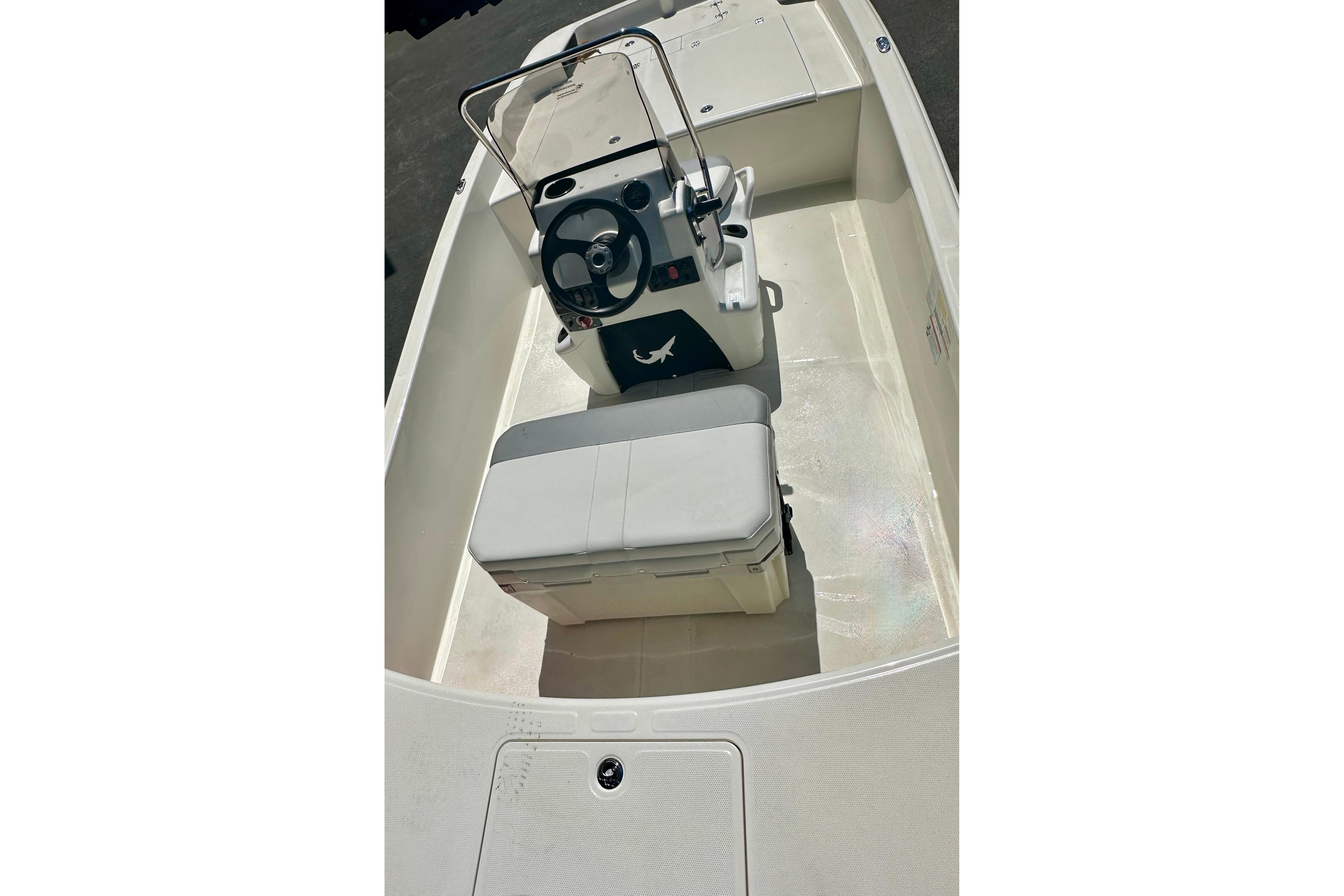 2026 Mako Pro Skiff 17 CC boat interior with steering console and seating.