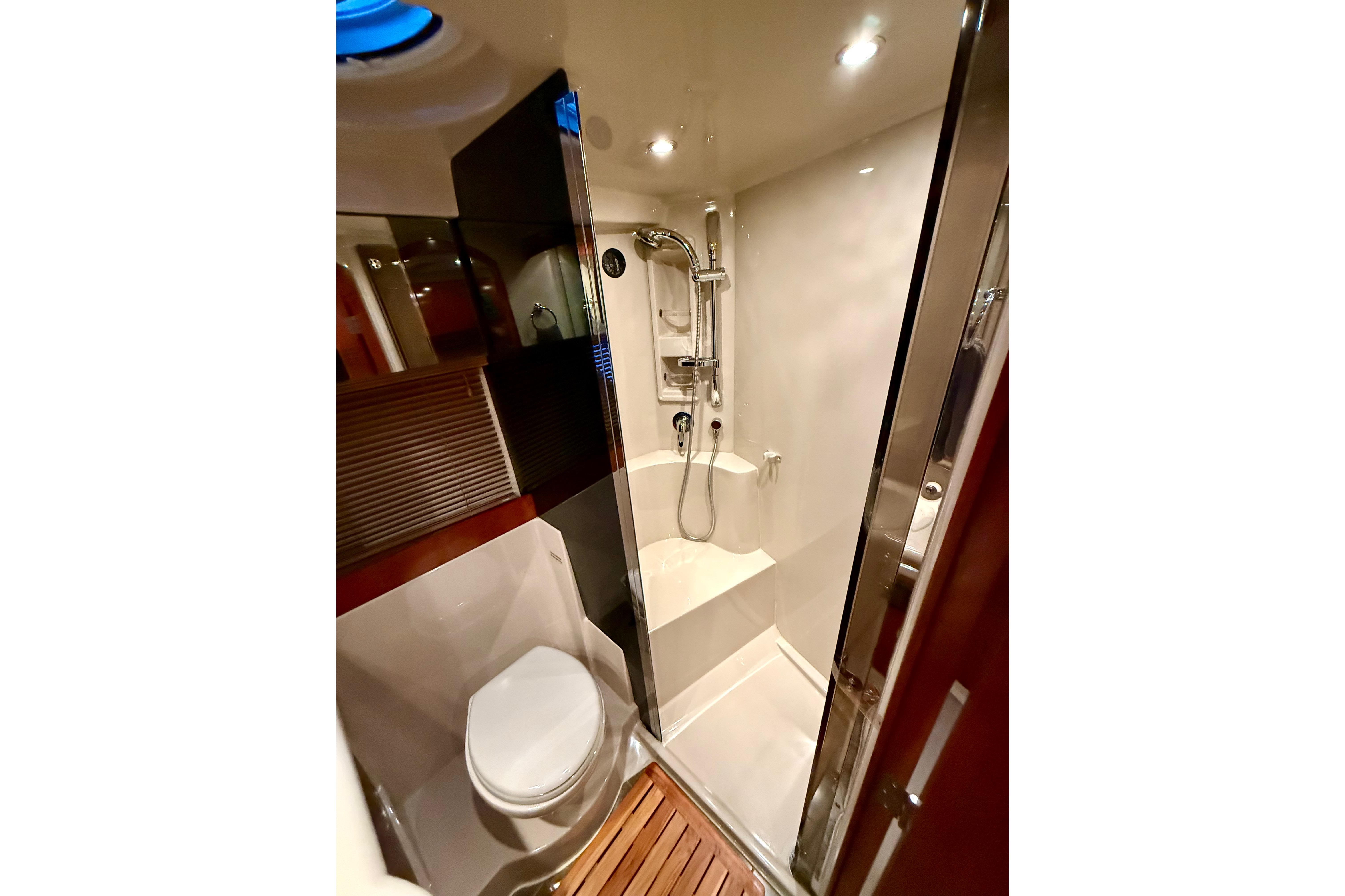 Luxurious bathroom in 2011 Cruisers Yachts 390 Sports Coupe with shower and toilet.