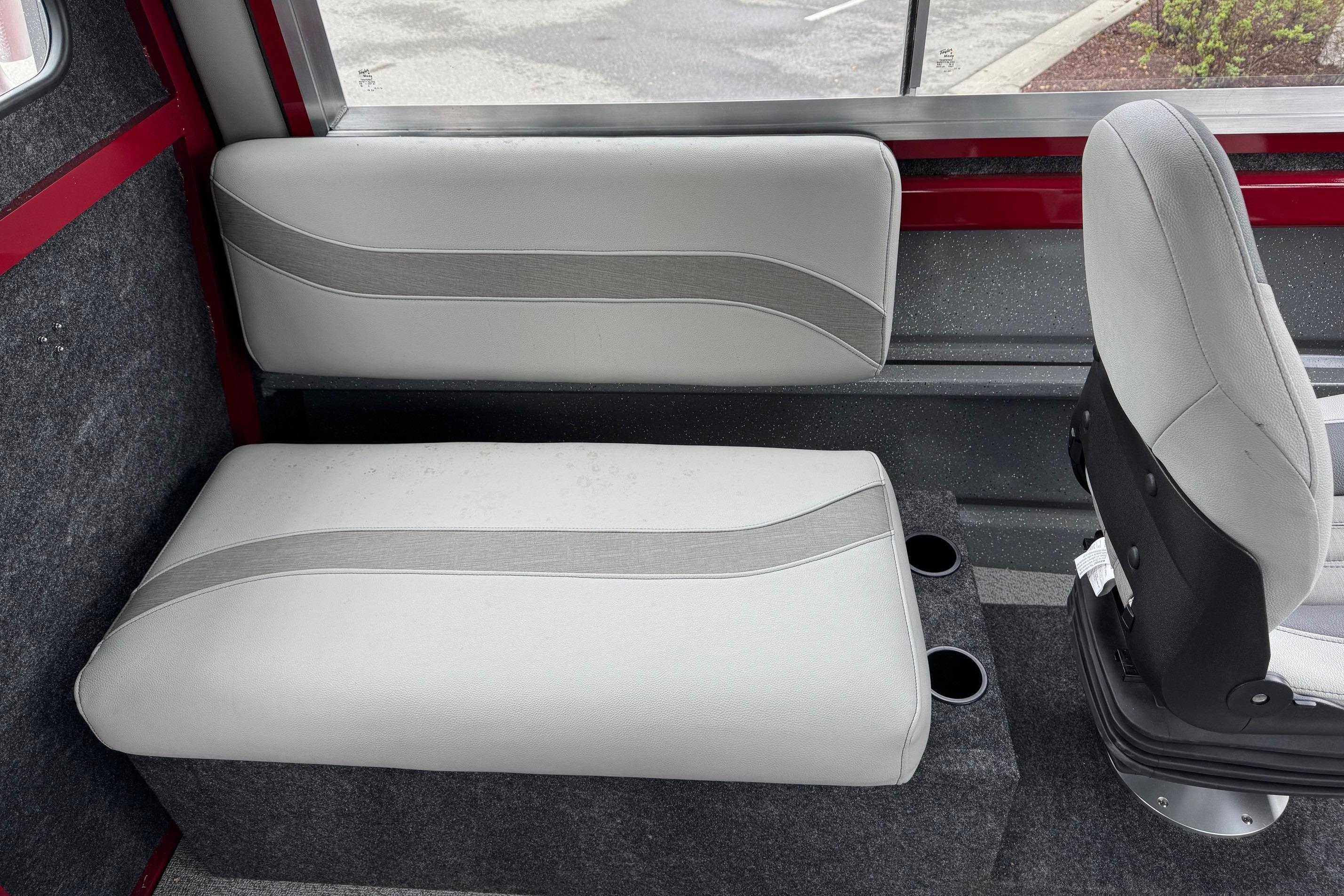 2024 Spartan 24 MAXIMUS PRO XL interior seating with gray upholstery and cup holders.