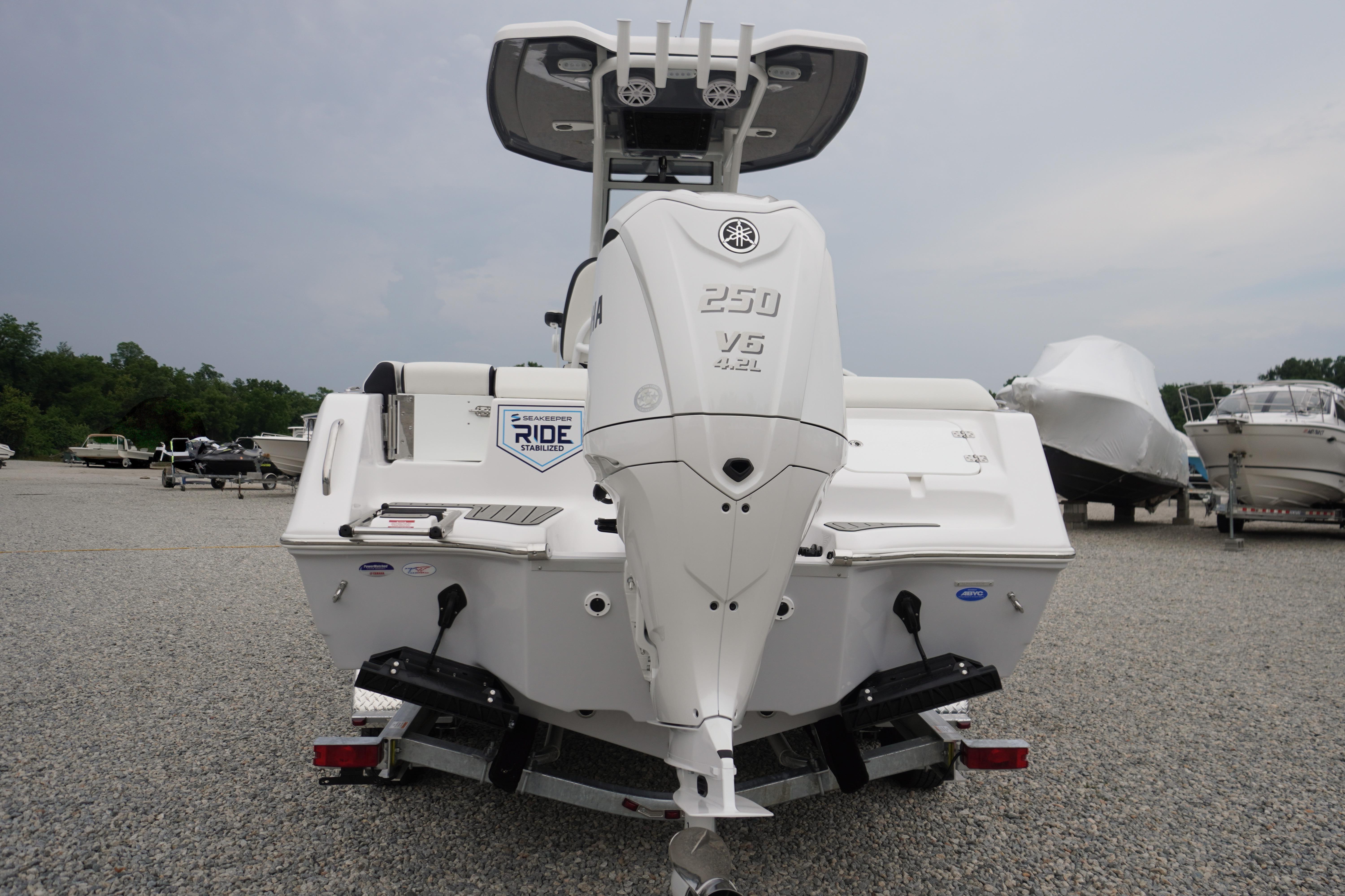 2026 Tidewater 232 SS boat with Yamaha 250 V6 engine, parked on gravel lot.