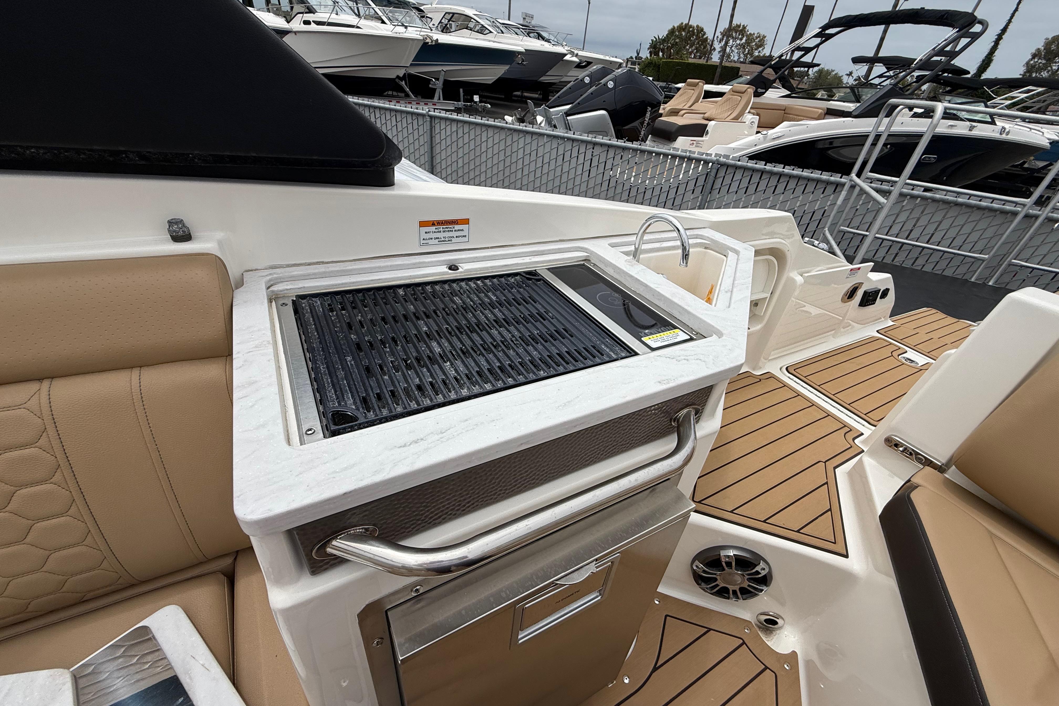 2022 Sea Ray SDX 290 Outboard boat interior with grill and seating area.
