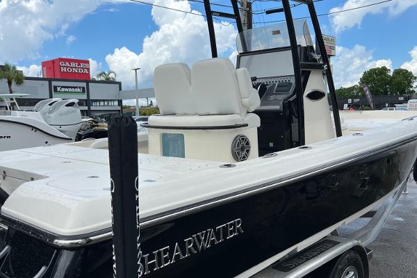 2024 ShearWater 260 Carolina Flare boat displayed at dealership under blue sky.