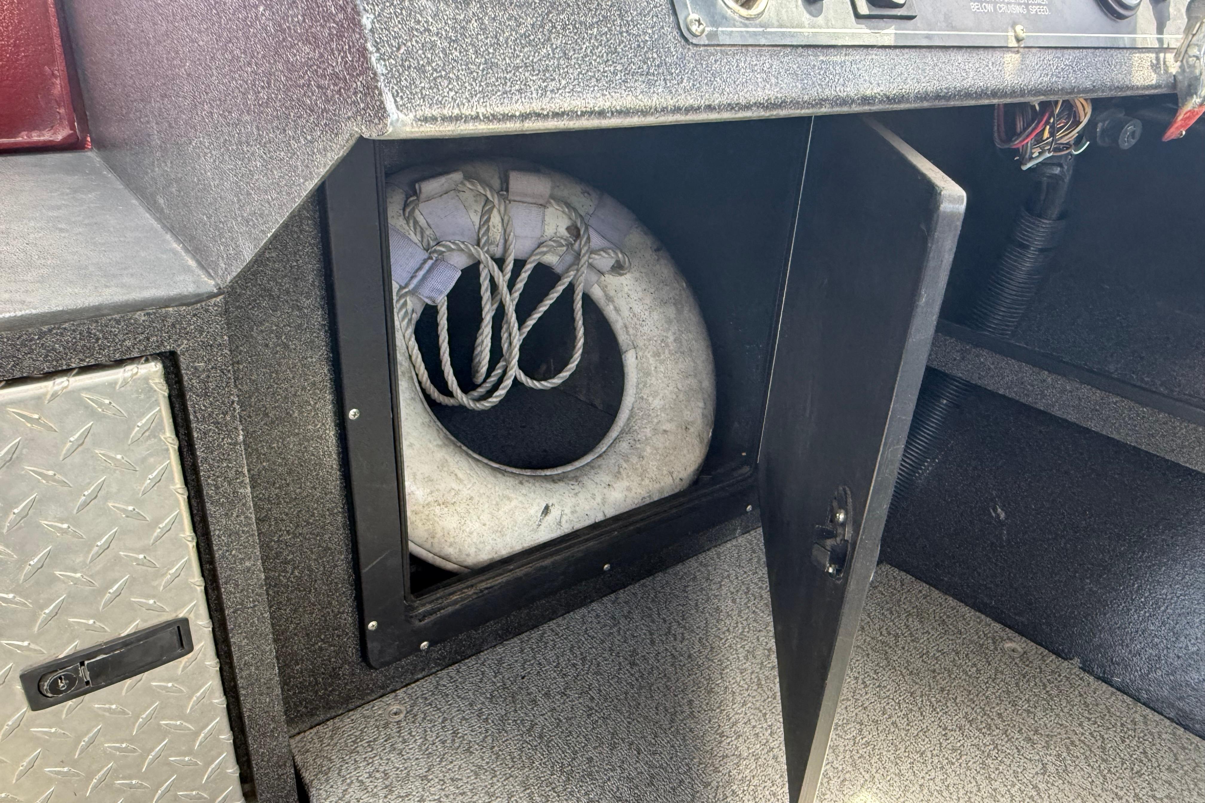 Storage compartment with life ring on a 2005 Willie Raptor 21' boat.