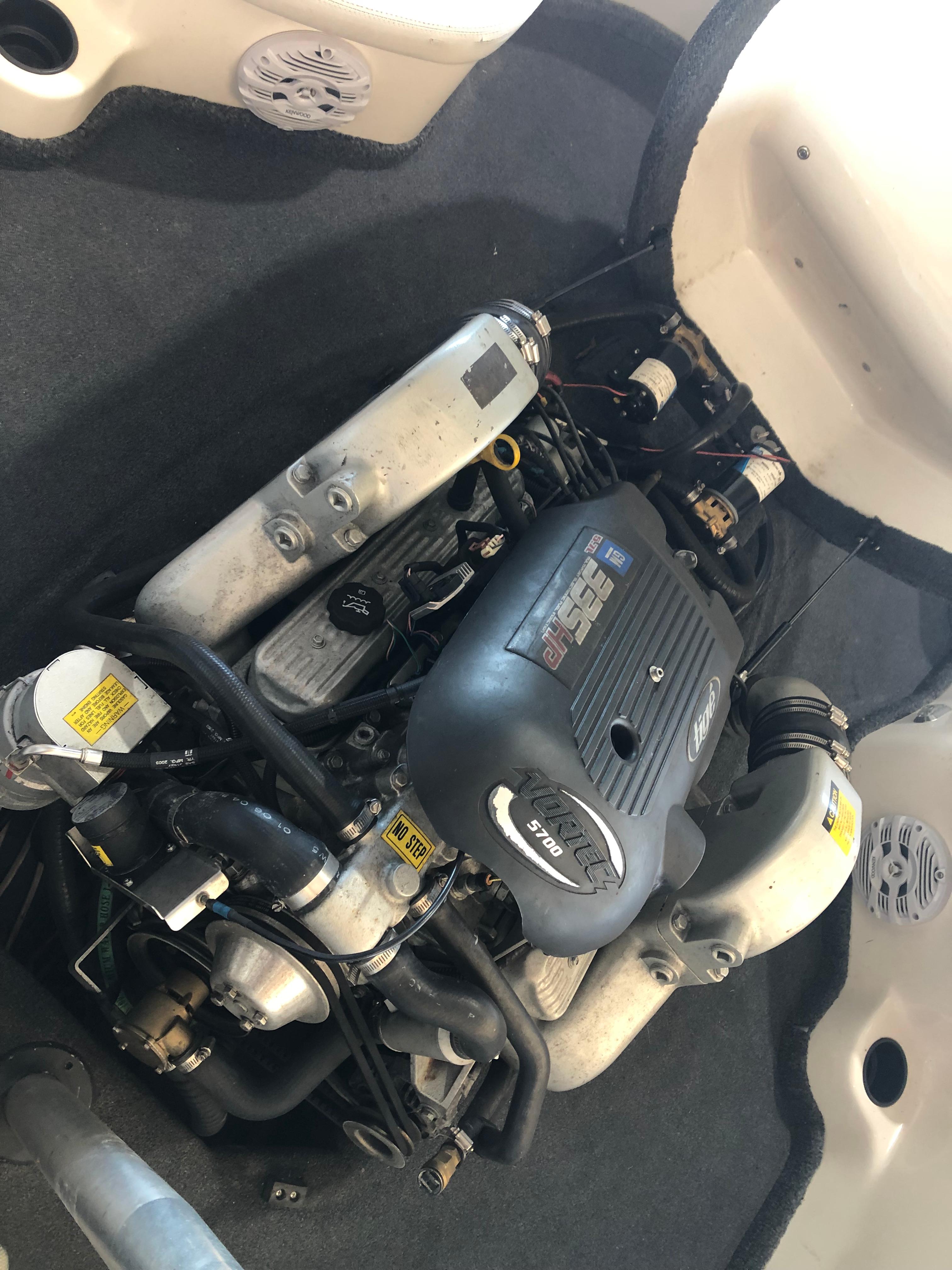 Engine compartment of a 2004 Tigé 22I TYPE R boat, showcasing the motor components.