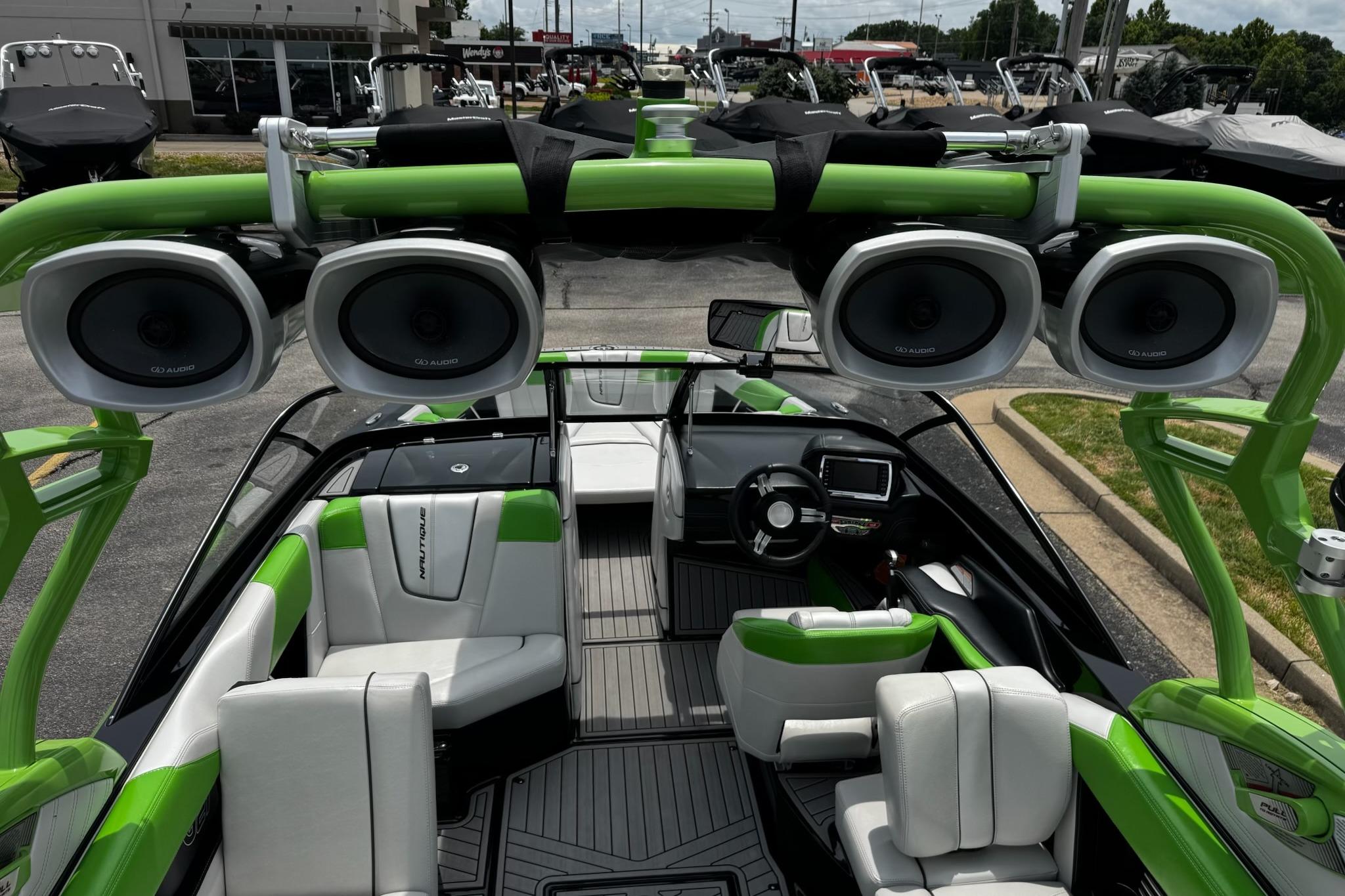 2014 Nautique Super Air Nautique G21 interior with green accents and premium audio system.