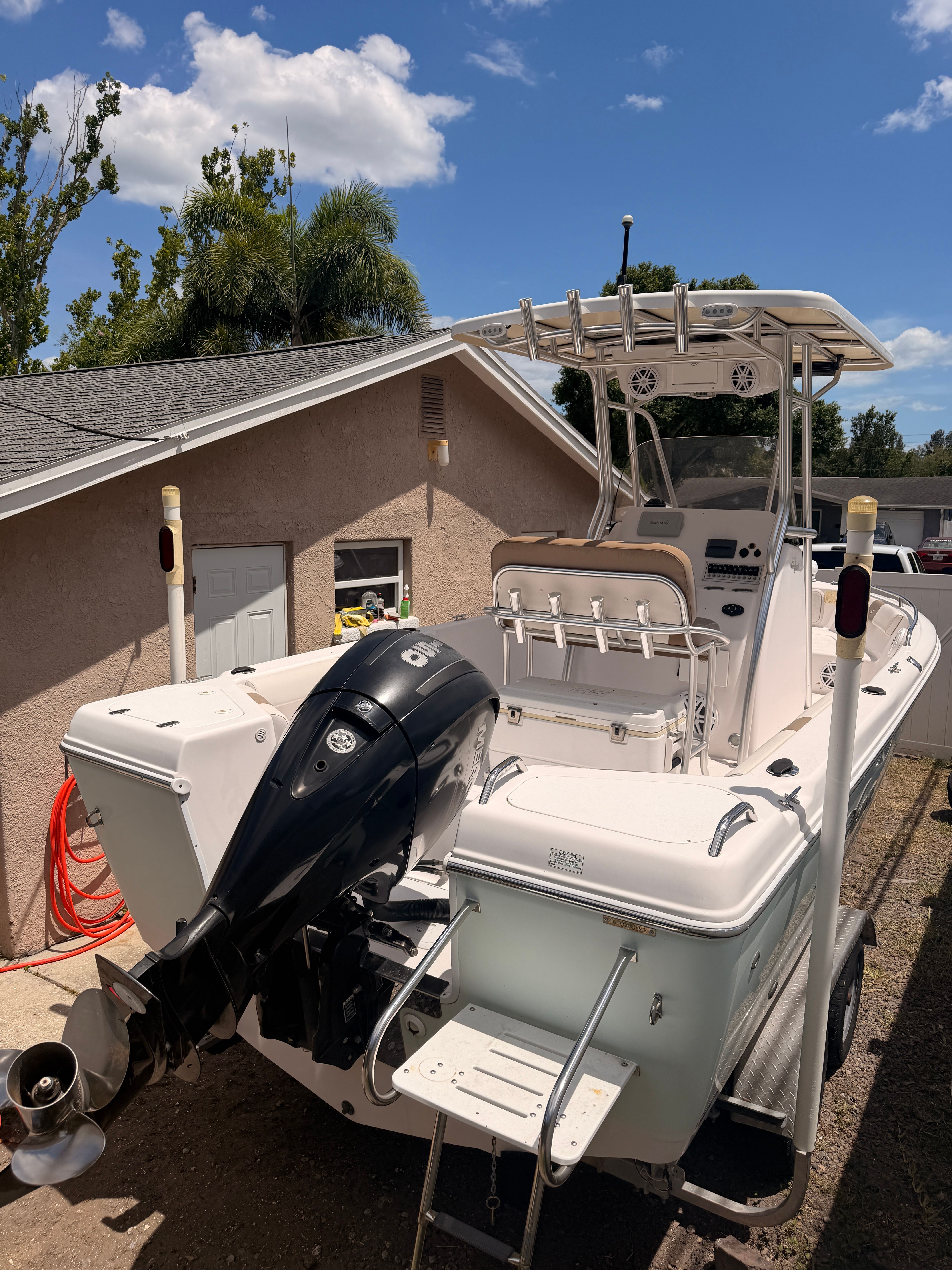 2017 Pro-Line 20 Sport boat parked in backyard.