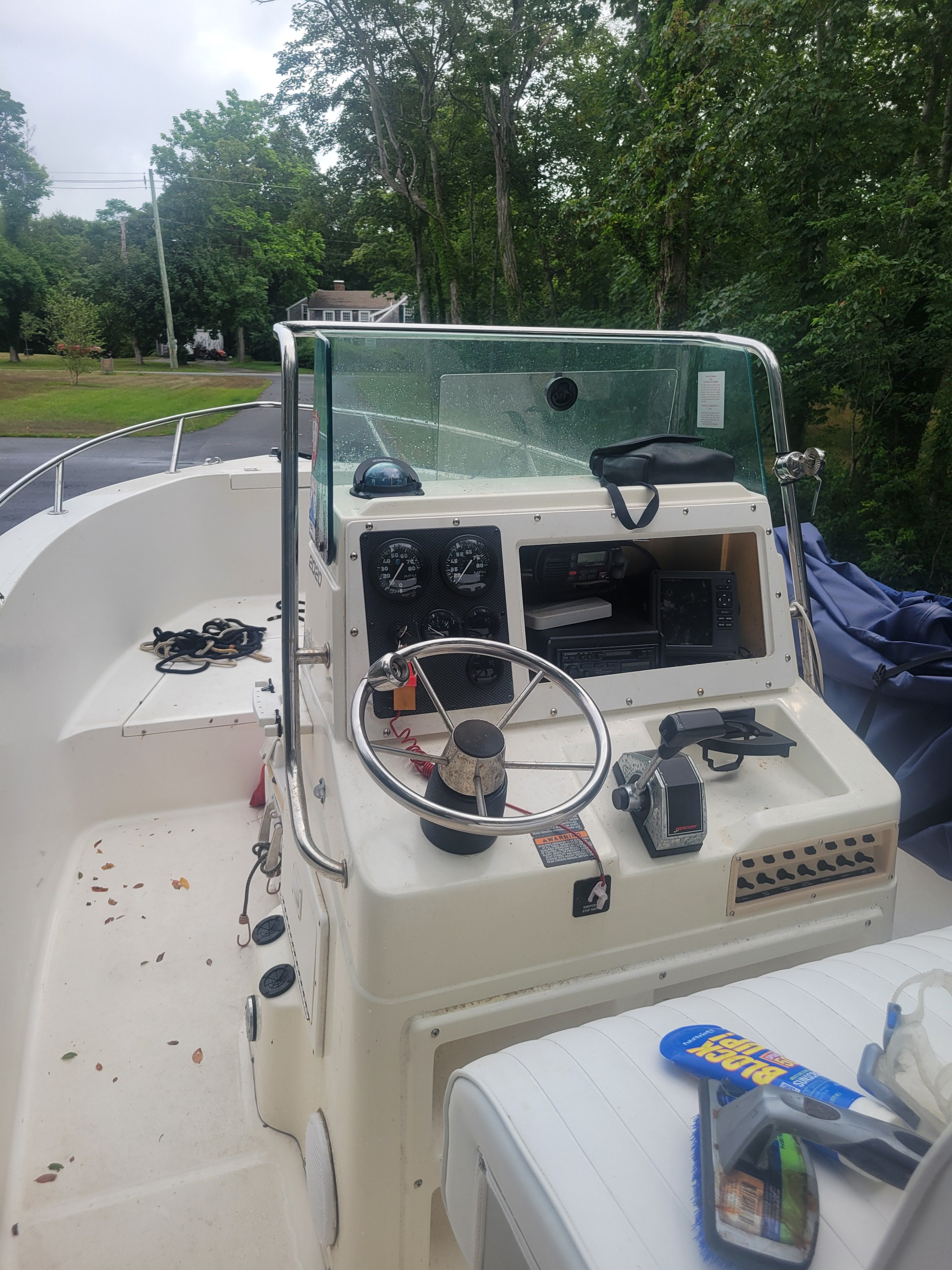 Robalo 2020 Center Console boat, 2001 model, with steering wheel and dashboard controls.