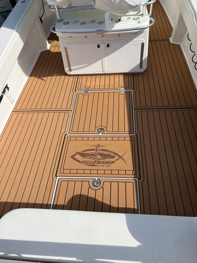 2006 Venture 39 Open boat with wooden deck and storage.