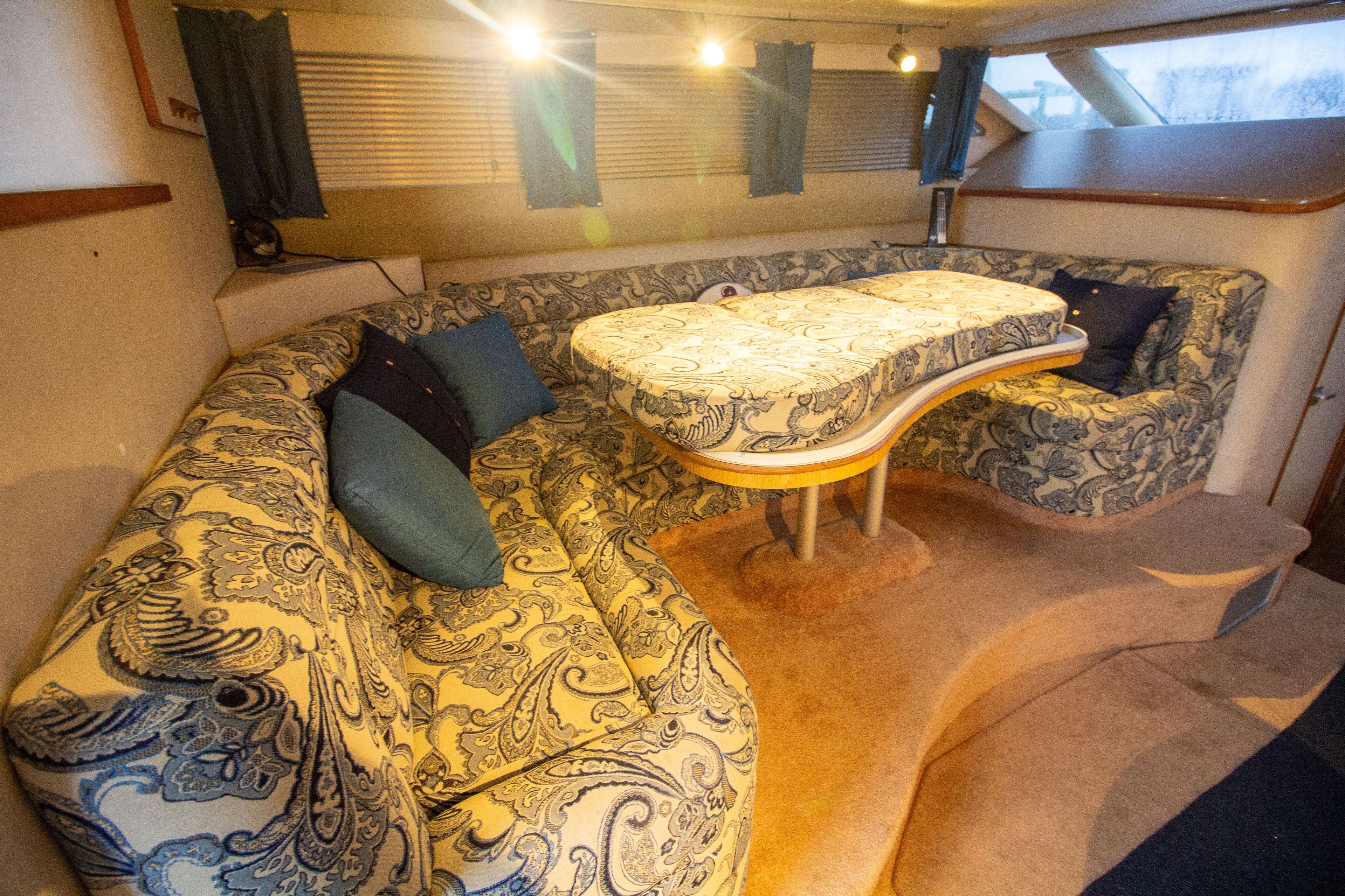 Interior of 1993 Sea Ray 440 Express Bridge yacht with patterned upholstery.
