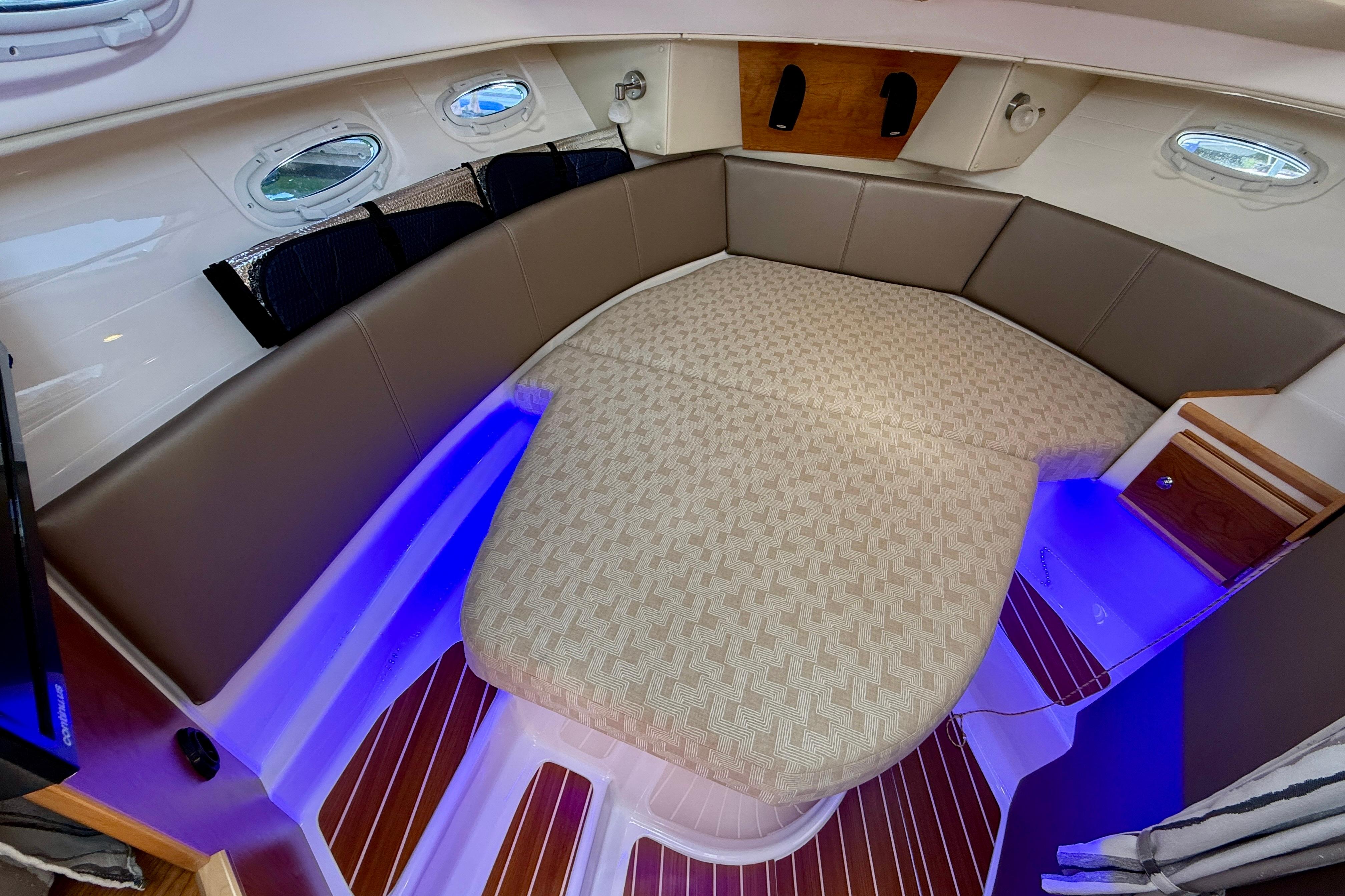 2023 Cutwater C-30 Sedan interior with cozy seating and ambient lighting.