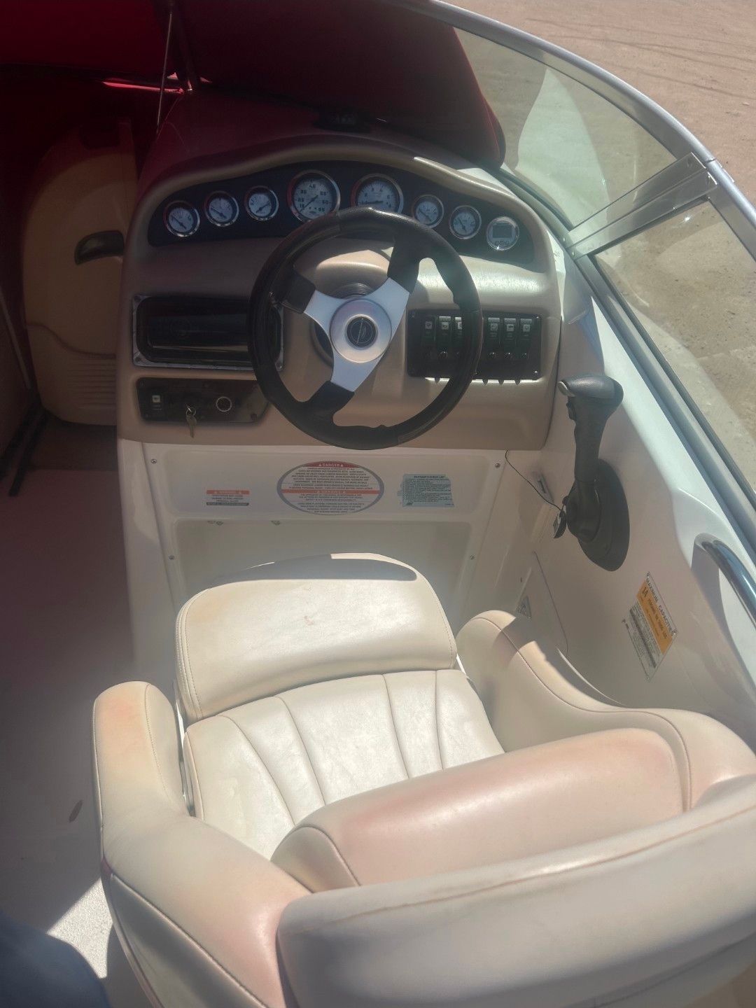 Interior view of a 2001 Chaparral Sunesta 233 boat cockpit.