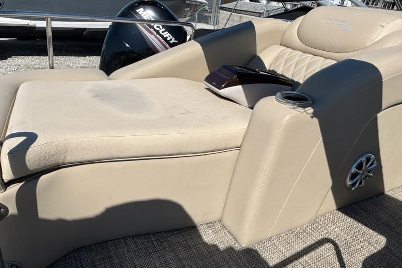 2014 Bennington 2575 RCW boat interior with beige seating and cup holder.