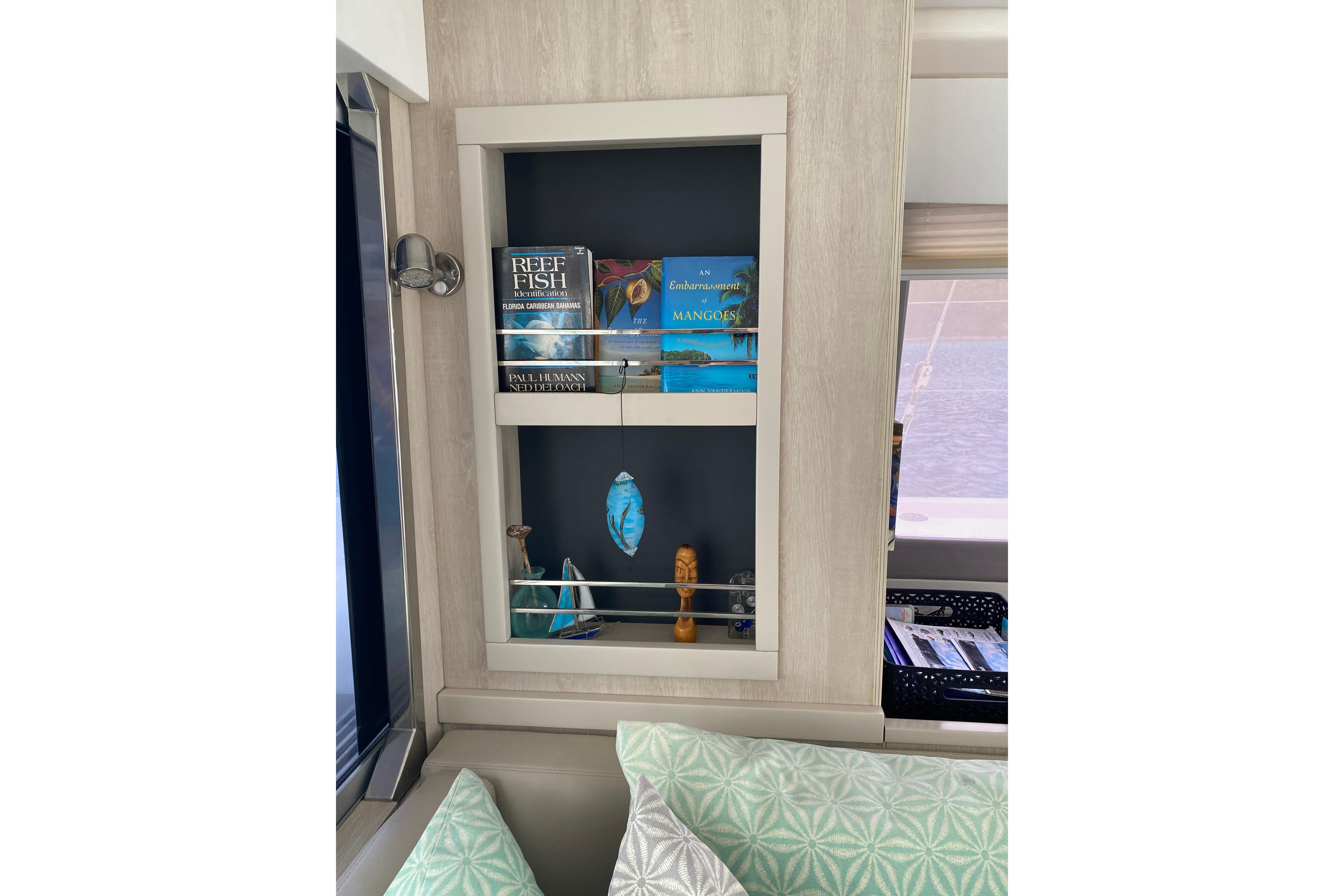 Bookshelf in 2017 Leopard 40 yacht interior with books and decorative items.