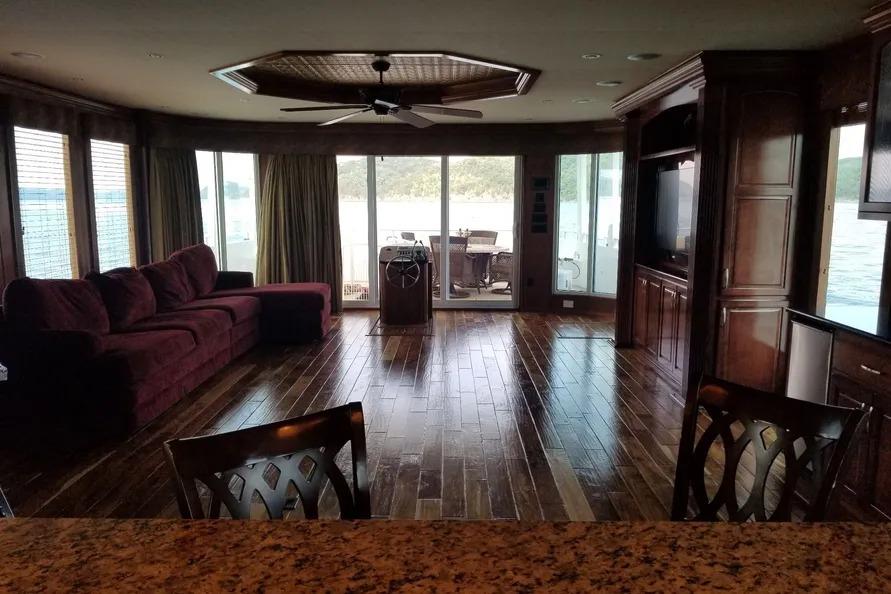Luxurious 2012 Thoroughbred Houseboat interior with elegant wood flooring and panoramic windows.