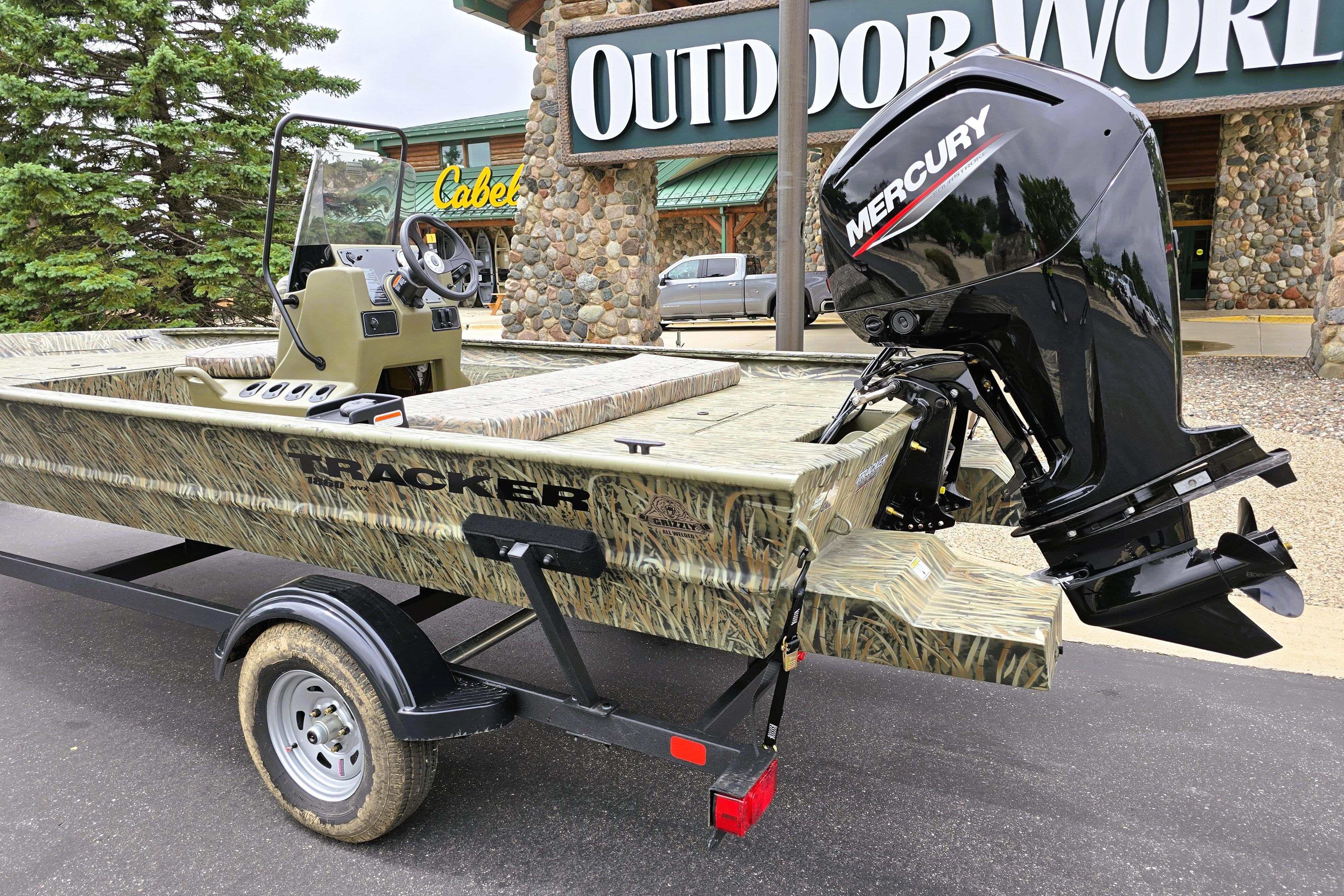 2026 Tracker Grizzly 1860 CC boat with Mercury engine outside outdoor store.