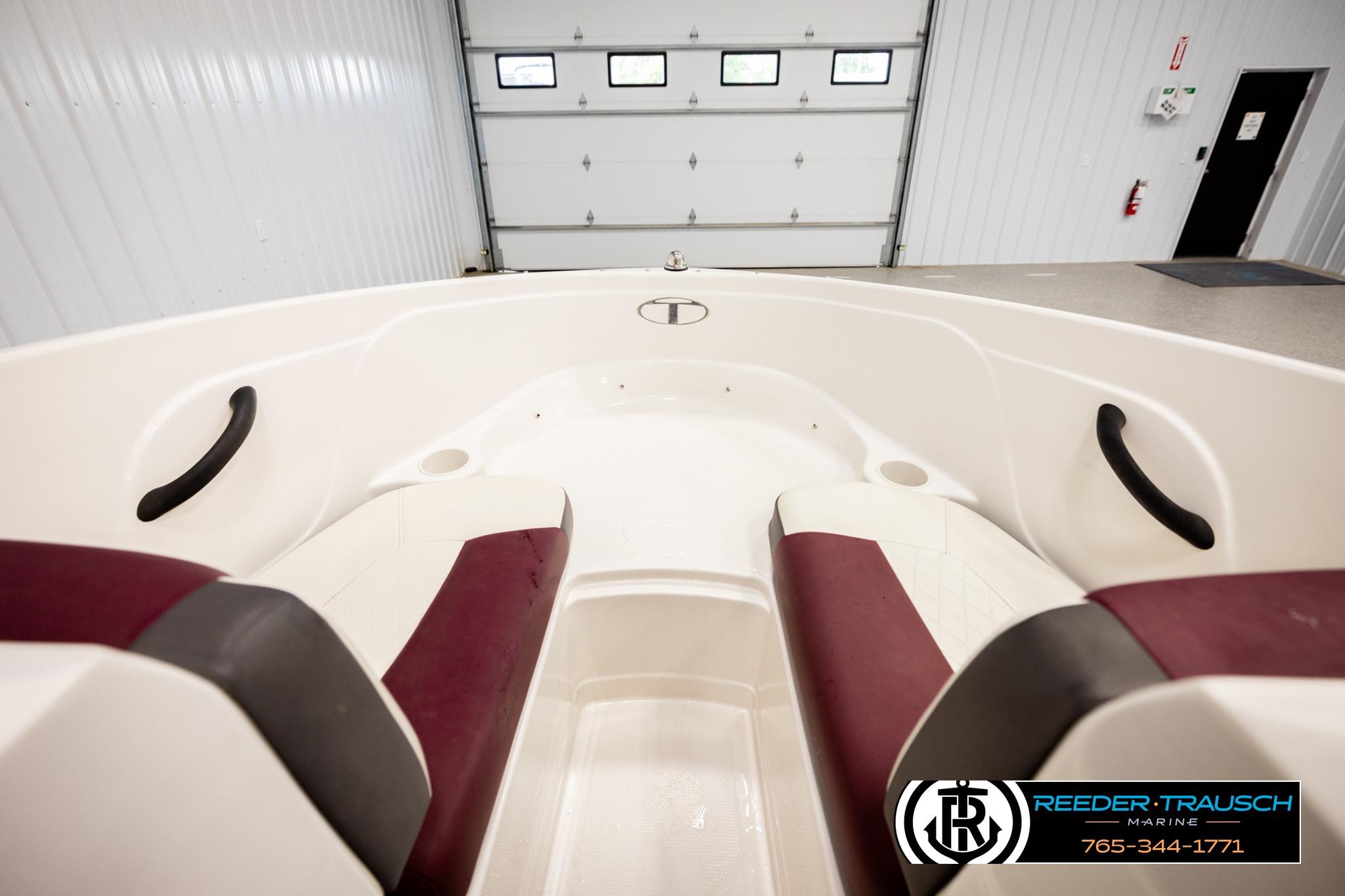 Interior view of a 2016 Tahoe 450 TS boat with maroon and white seating.